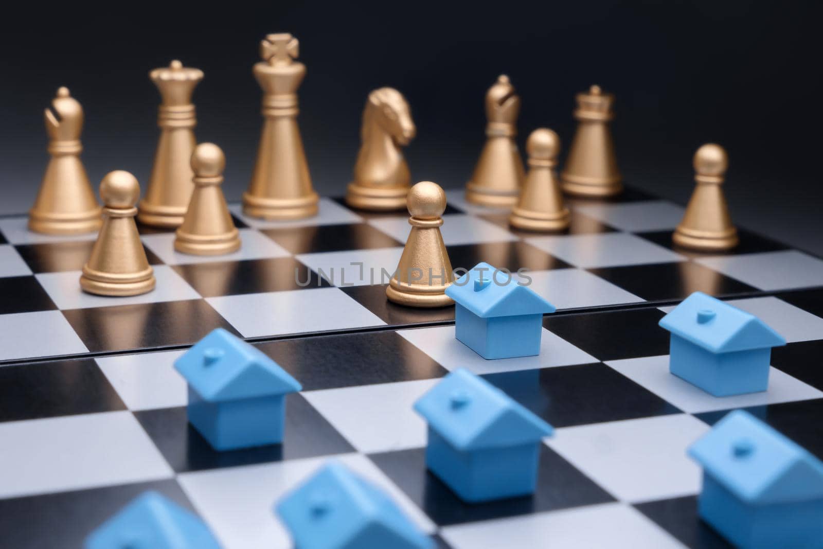 Blue miniature houses property development strategy planning on chess board. Property management. Model house real estate business strategy game chess property home mortgage marketing plan competition by synel