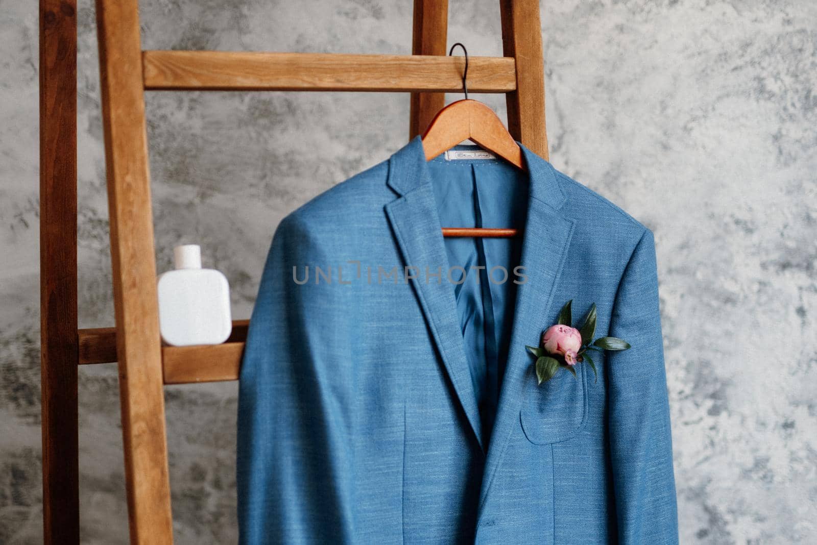 blue blazer classic suit hanging on a wooden ladder