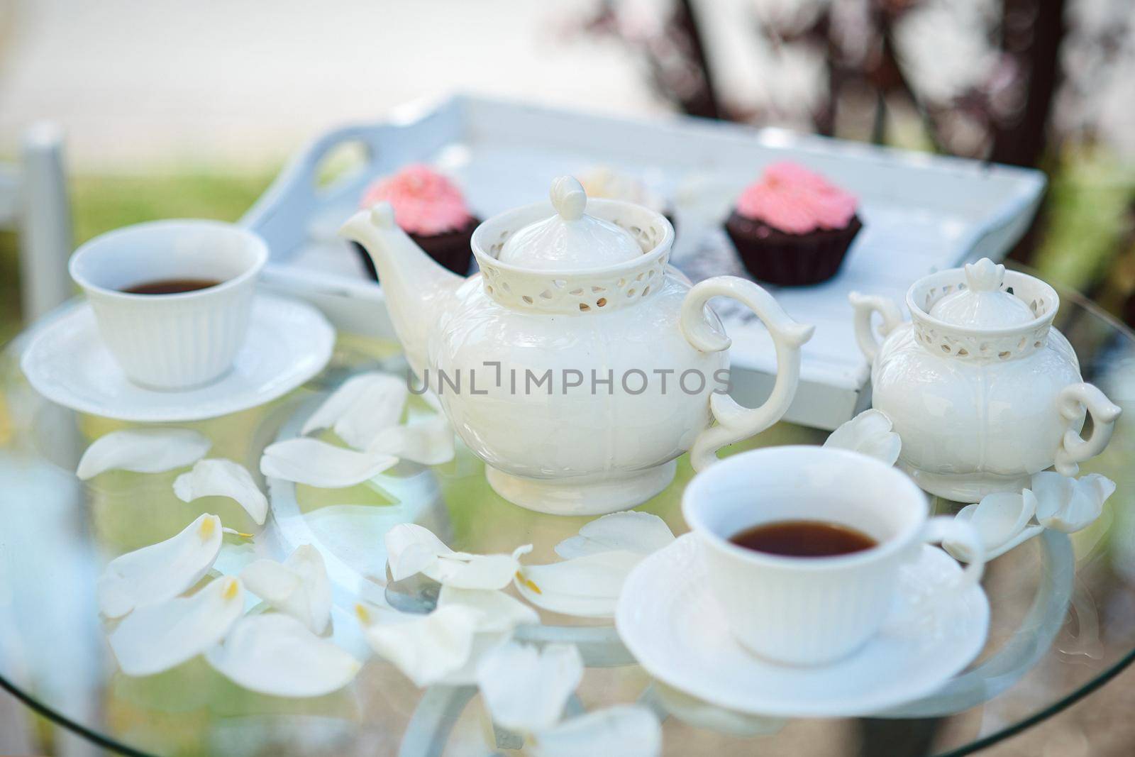 Tea drinking black tea with porcelain cups and a teapot