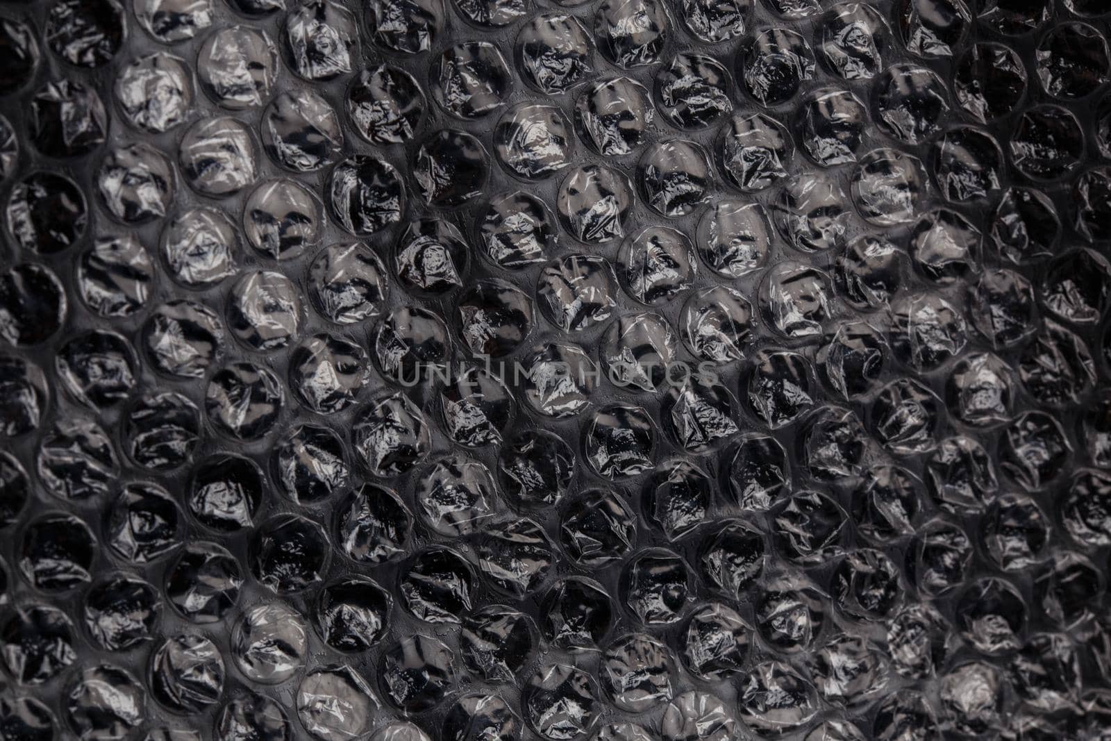 dark air bubble wrap - real life close-up texture and background by z1b