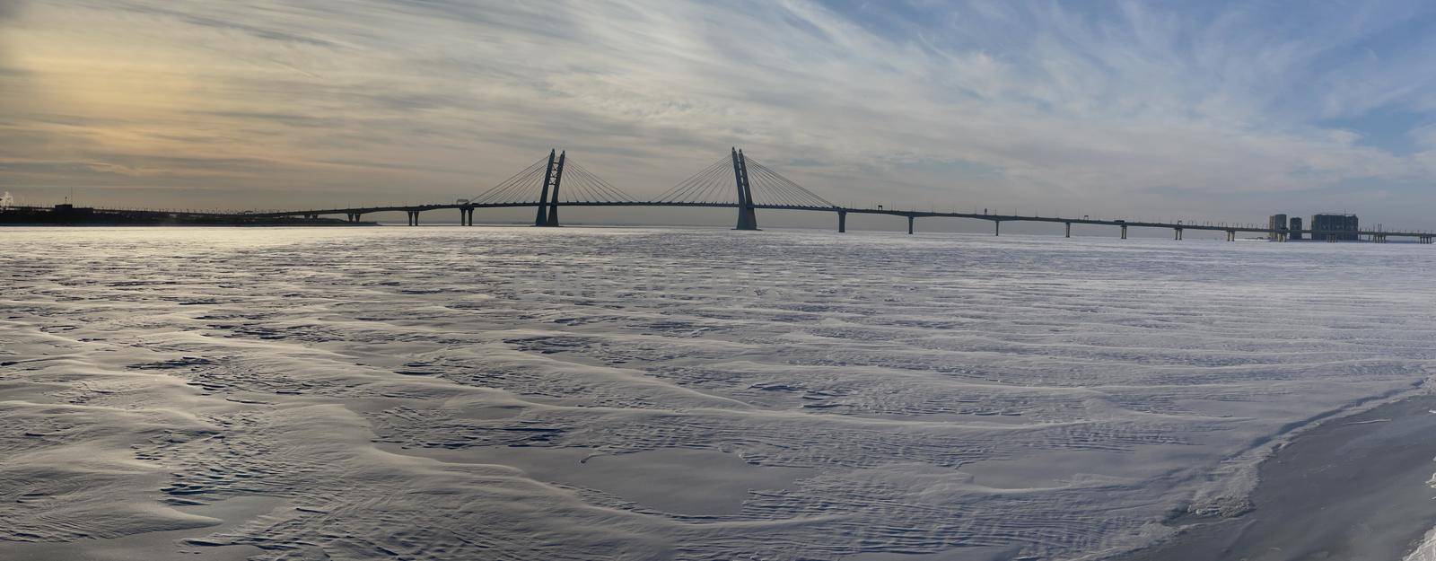 Winter panorama of the Guy three-flying pilonny bridge through the Ship waterway at sunset, Russia, Saint Petersburg, The frozen river Neva, by vladimirdrozdin