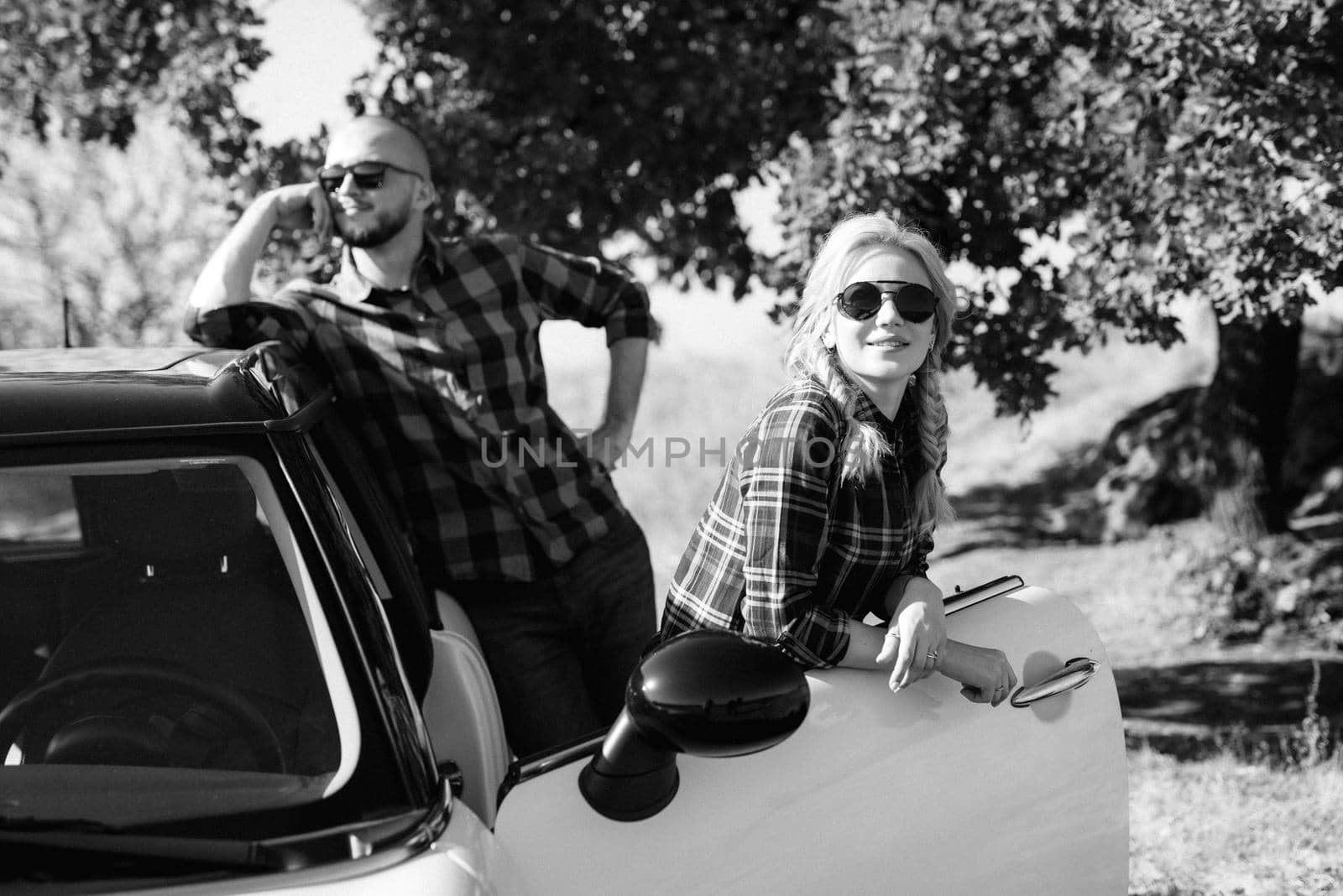 traveling by car of a young couple of a guy and a girl in plaid shirts