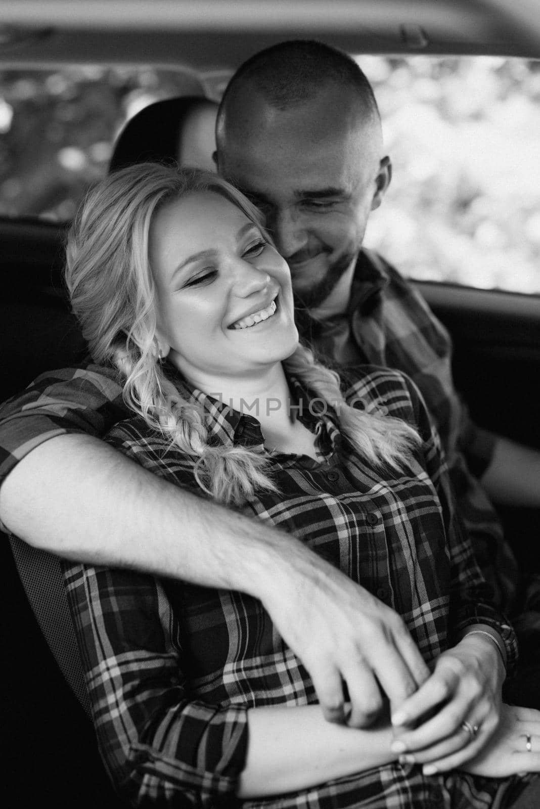 traveling by car of a young couple of a guy and a girl in plaid shirts