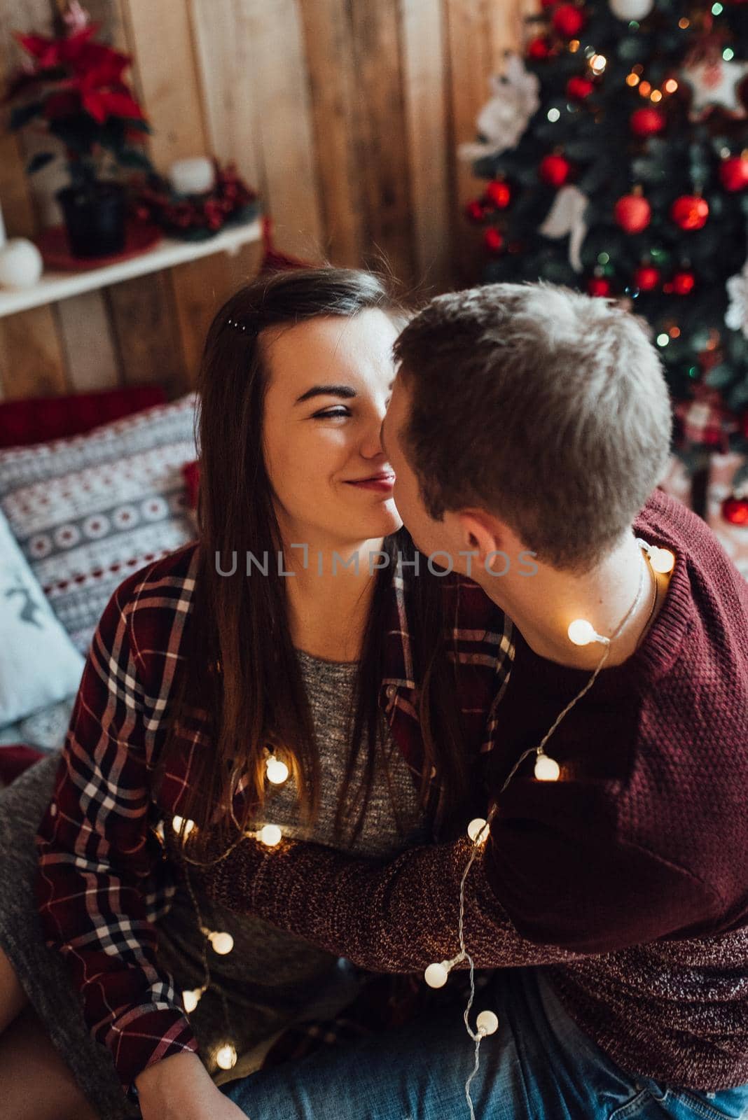 a guy and a girl celebrate the new year together
in a warm atmosphere and give each other gifts