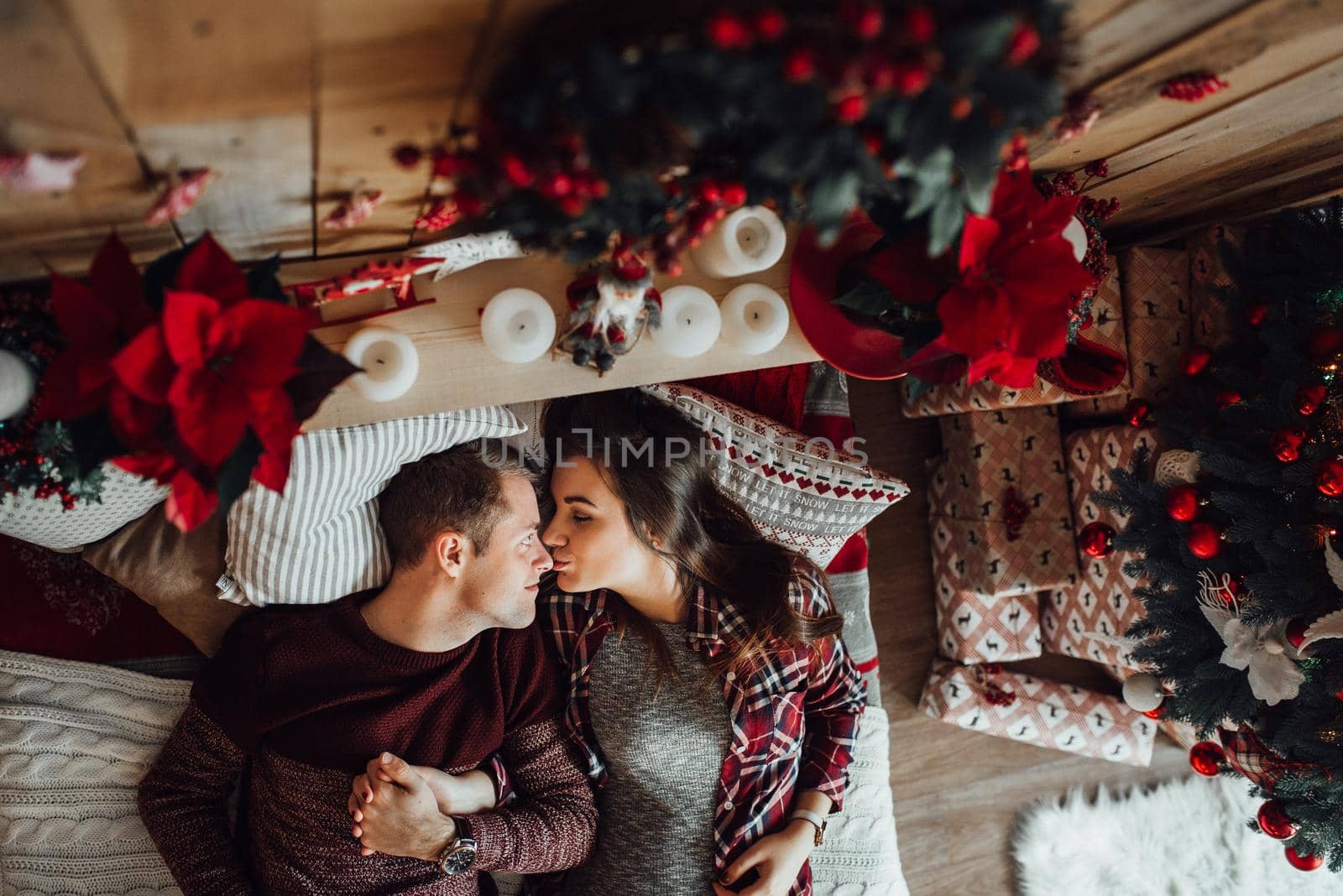 a guy and a girl celebrate the new year together
in a warm atmosphere and give each other gifts