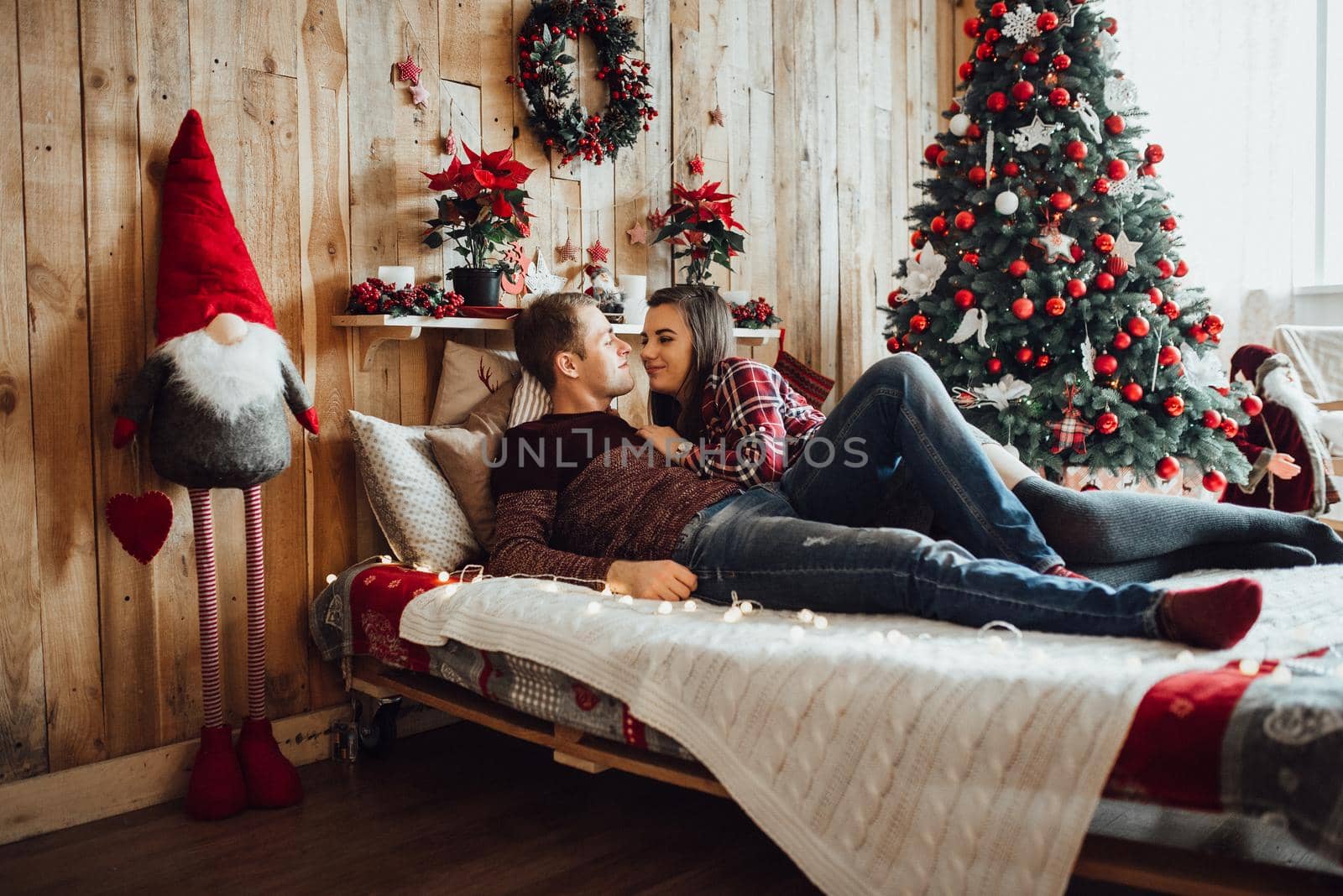 a guy and a girl celebrate the new year together
in a warm atmosphere and give each other gifts