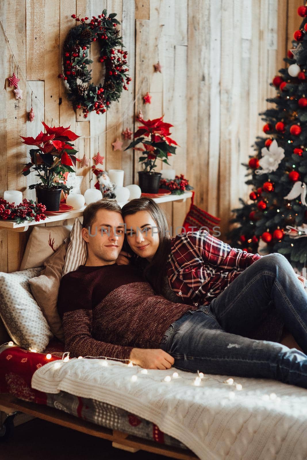 a guy and a girl celebrate the new year together
in a warm atmosphere and give each other gifts