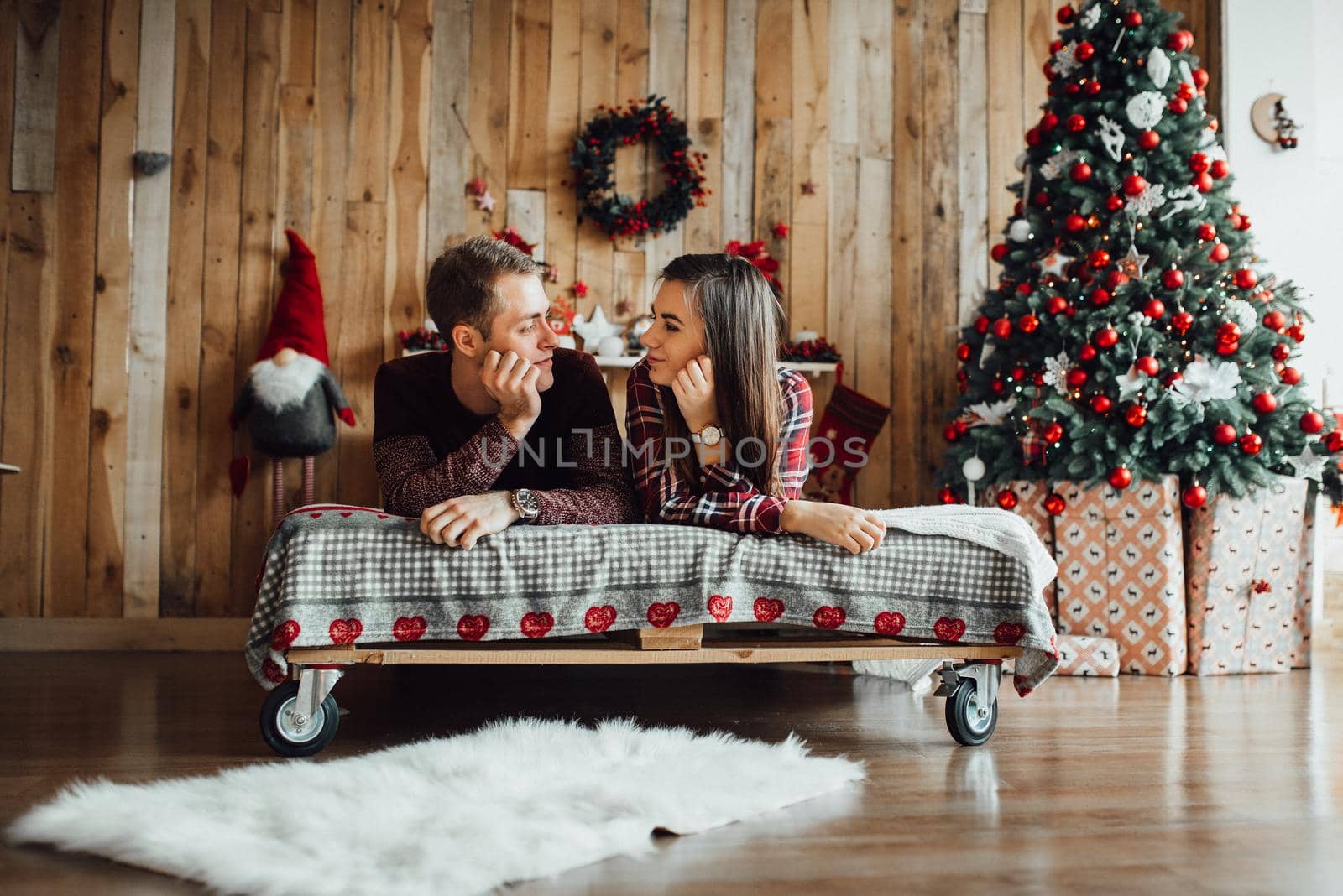 a guy and a girl celebrate the new year together
in a warm atmosphere and give each other gifts