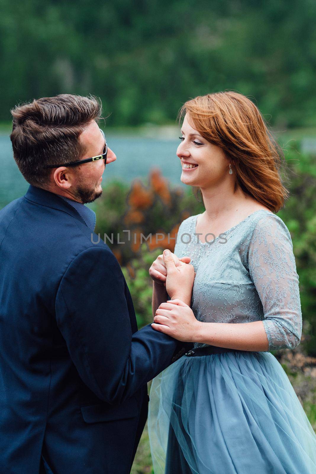 young couple on a walk near the lake surrounded by the Carpathian mountains