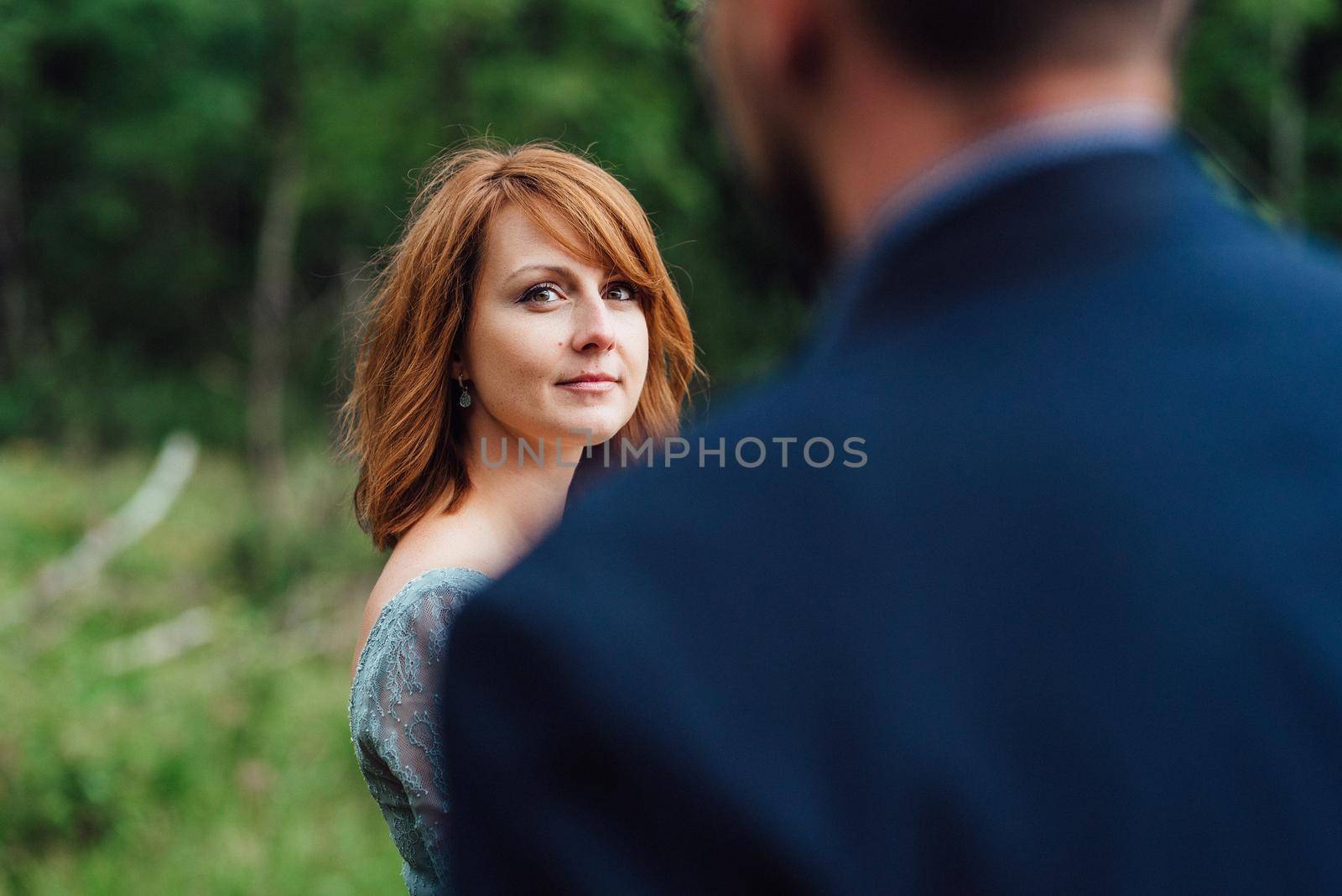 young couple on a walk near the lake surrounded by the Carpathian mountains