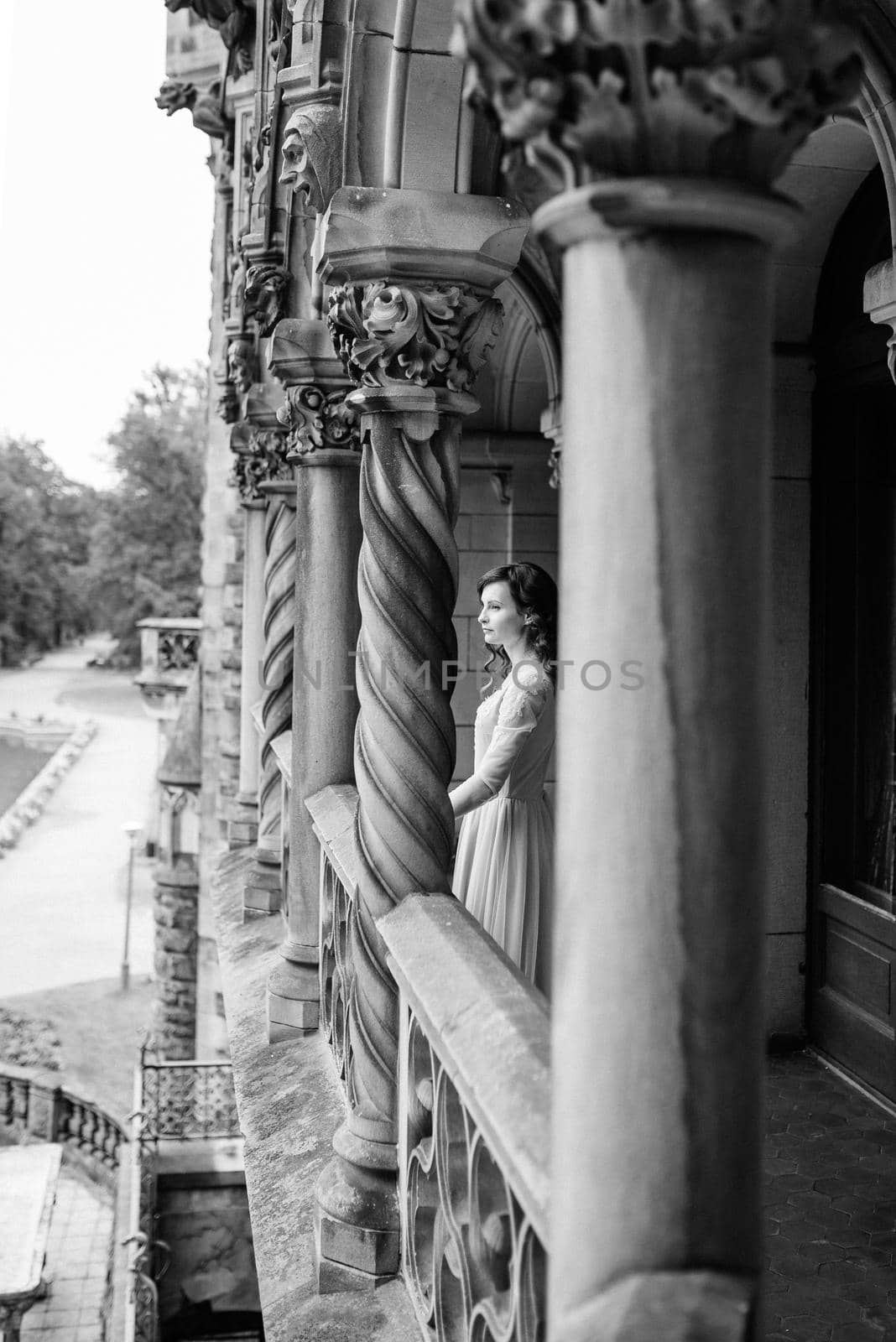 A girl in a light pink dress against the background of a medieva castle by Andreua