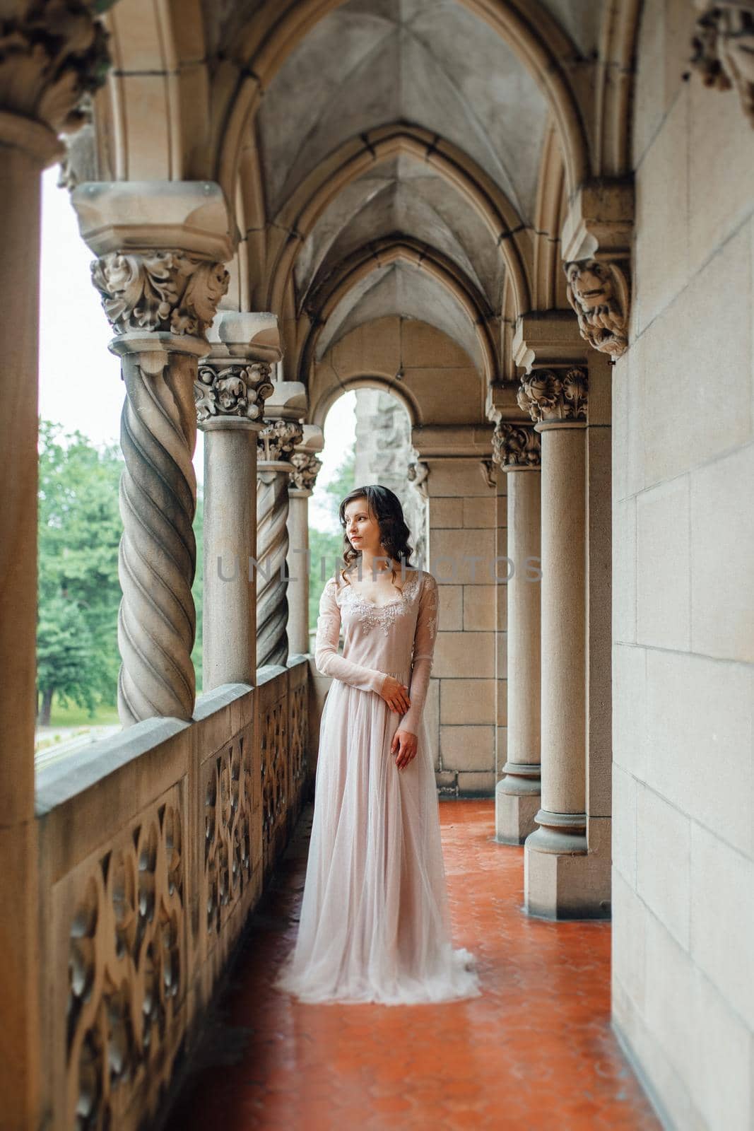 A girl in a light pink dress against the background of a medieva castle by Andreua