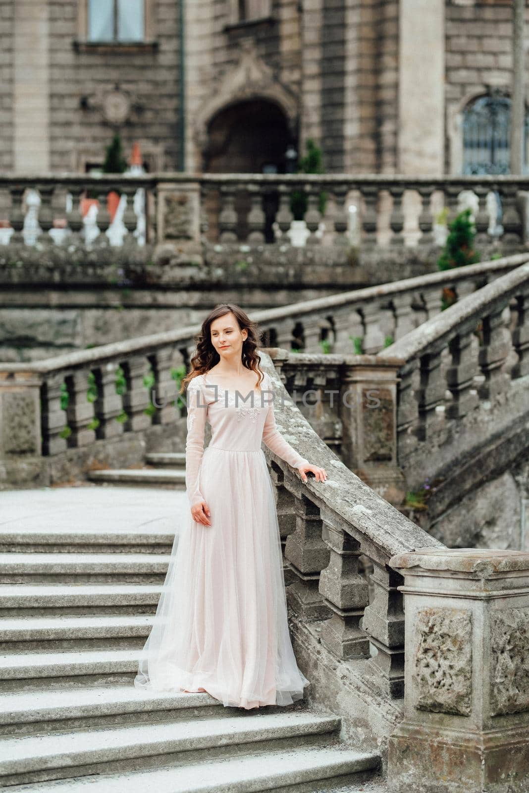 A girl in a light pink dress against the background of a medieva castle by Andreua