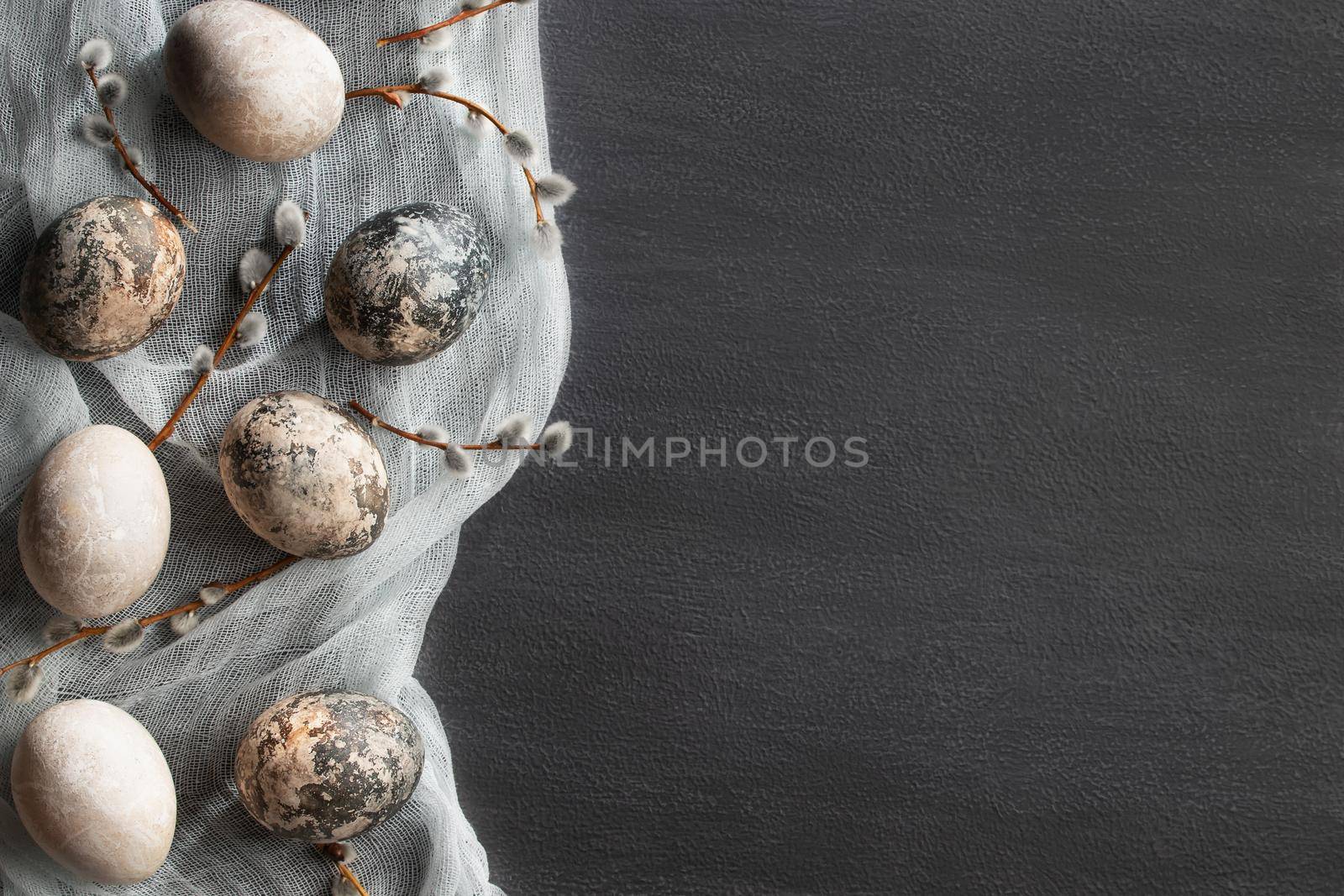 Easter composition - several painted with natural dyes with marble effect on the table, top view, copy space.