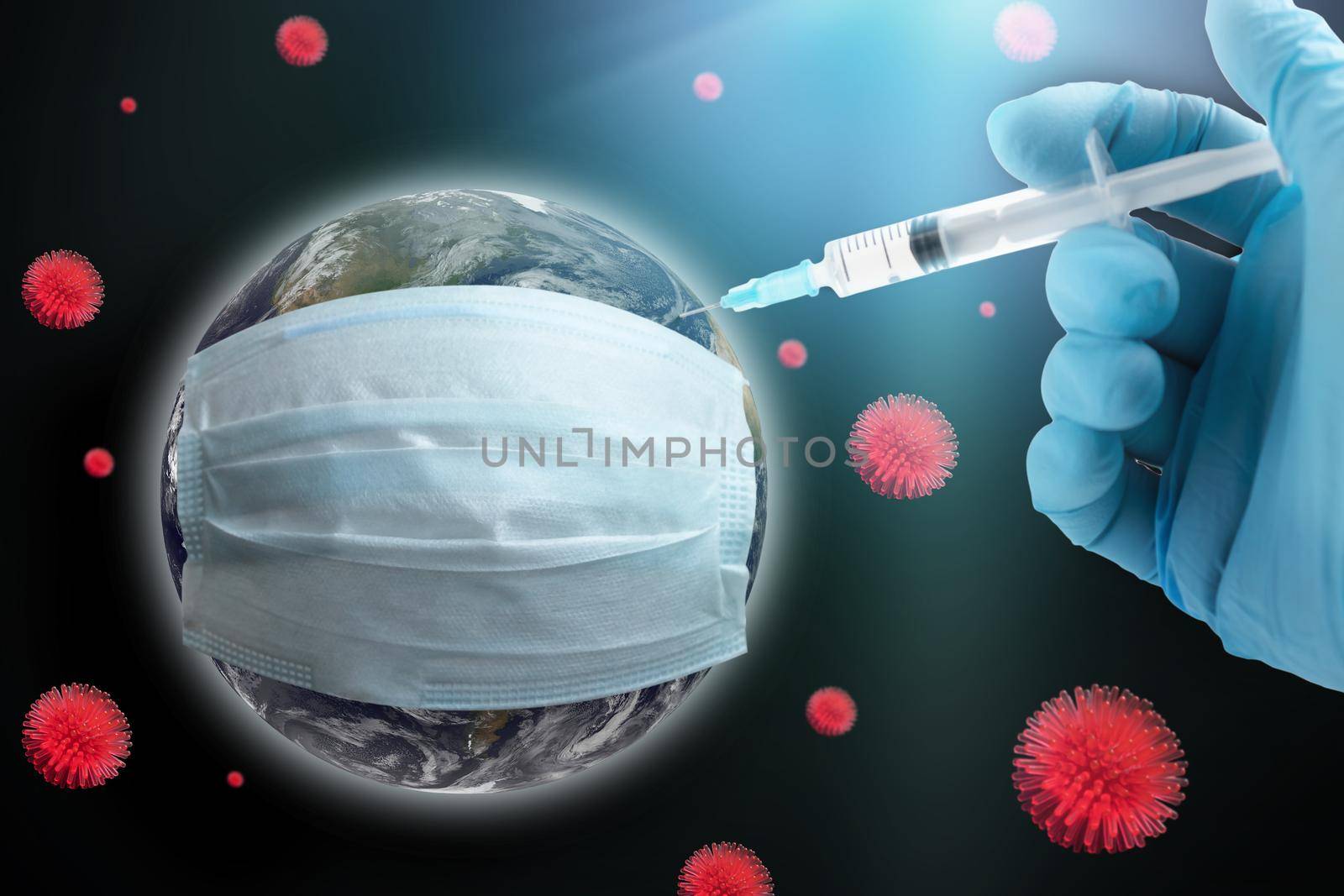 Coronavirus global vaccination concept. Earth in a protective mask, hand with a syringe makes an injection. Earth image courtesy of NASA.