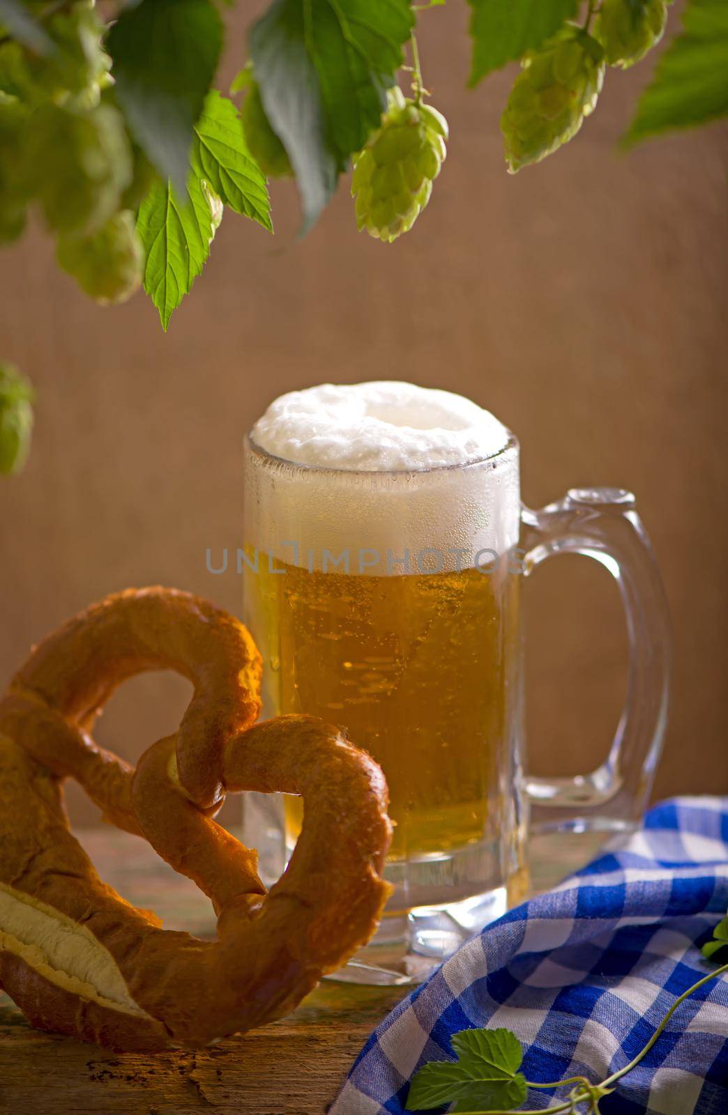 Bavarian Oktoberfest beer and pretzels on wooden table.