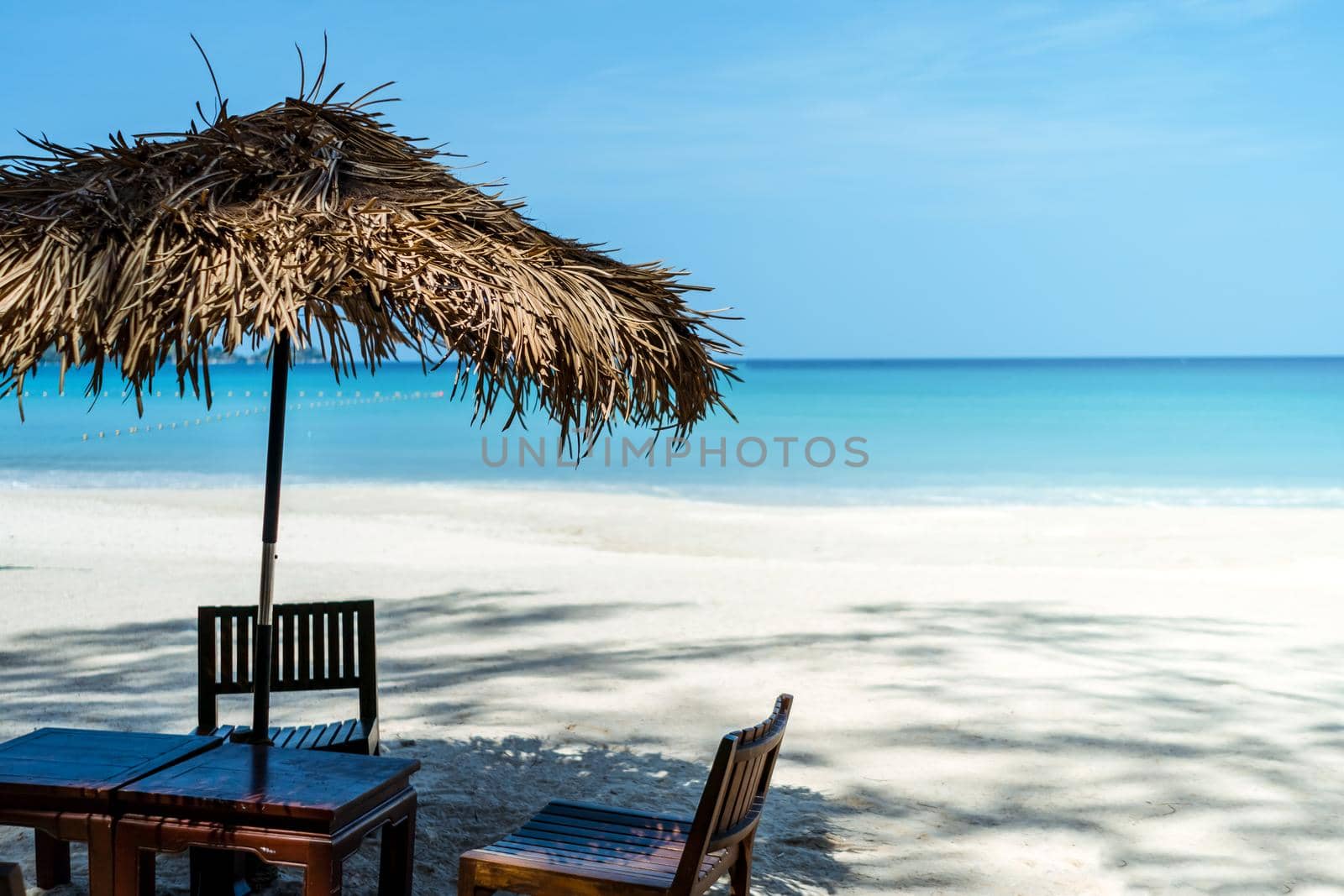 Table and chair at tropical summer beach background.