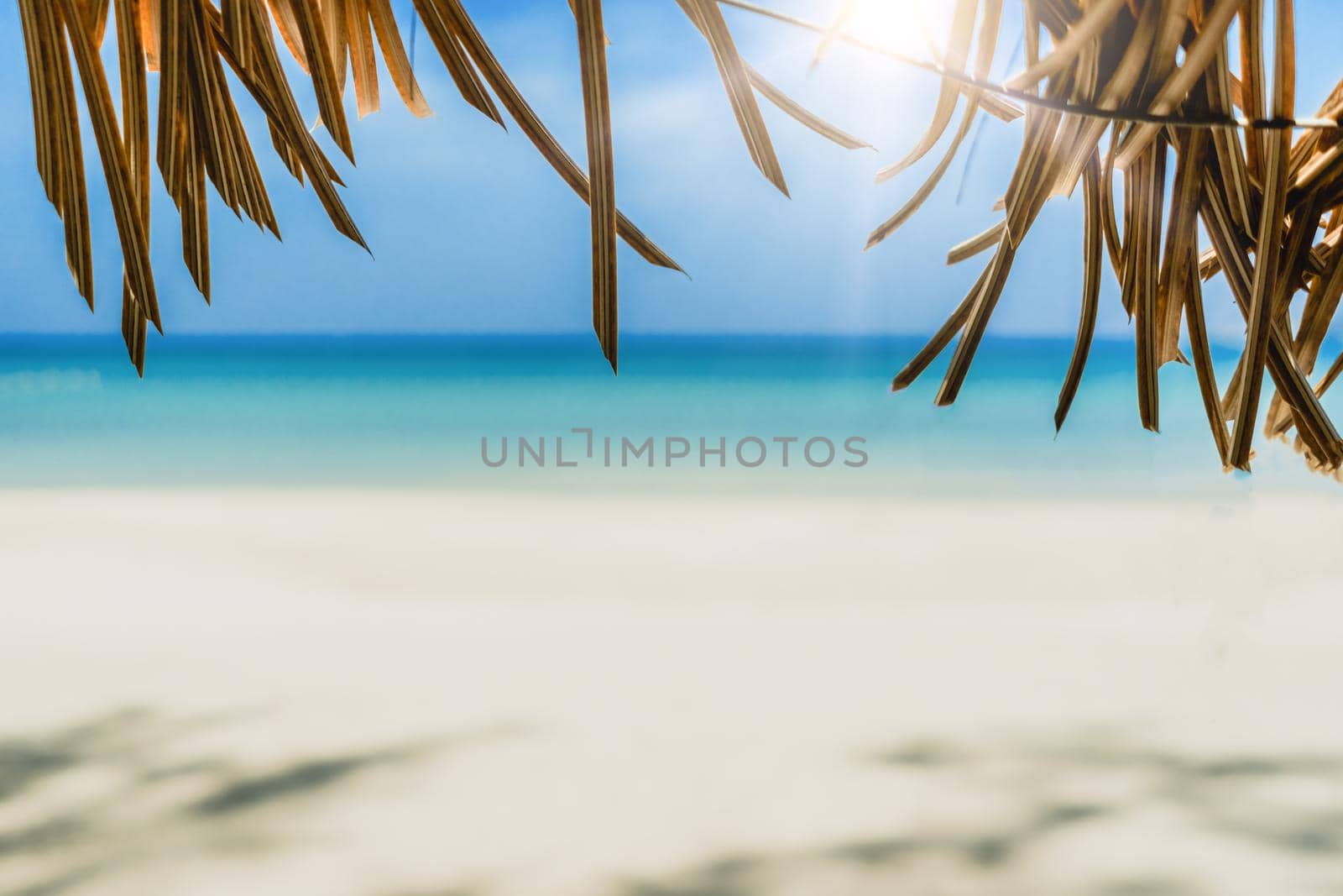 Tropical nature clean beach and white sand in summer season with sun light blue sky background.