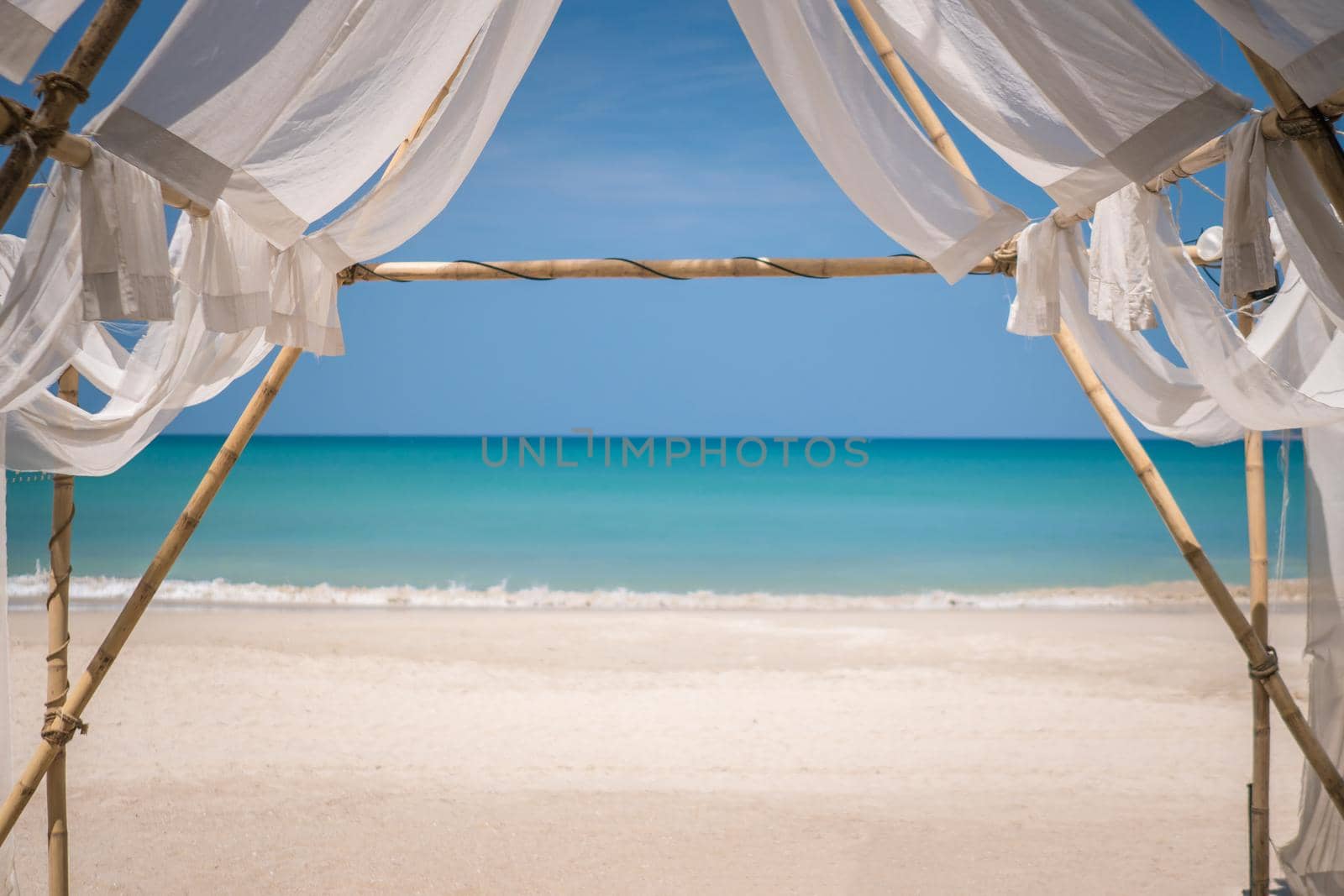 Tropical nature clean beach and white sand in summer season with sun light blue sky background.