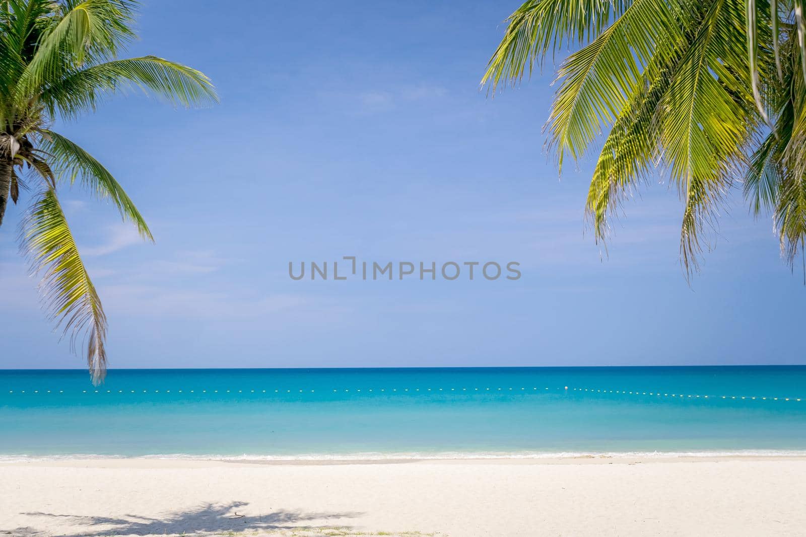 Tropical nature clean beach and white sand in summer with sun light blue sky background. by Suwant