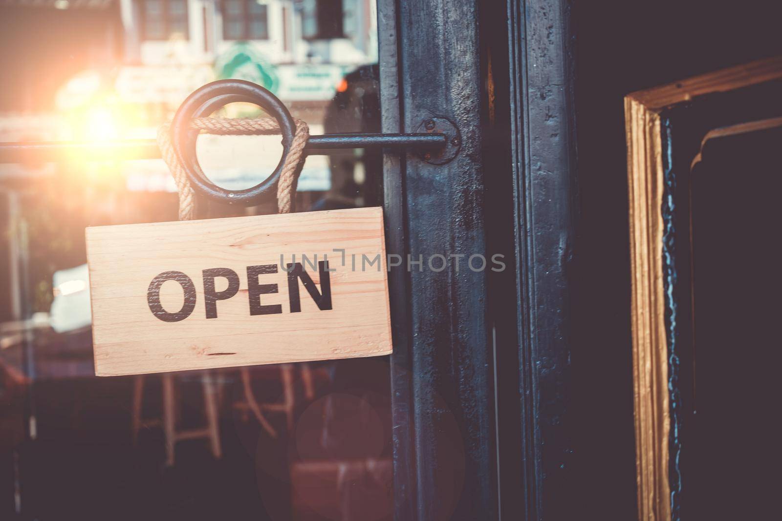 A business sign that says ‘Open’ on cafe or restaurant hang on door at entrance.  by Suwant