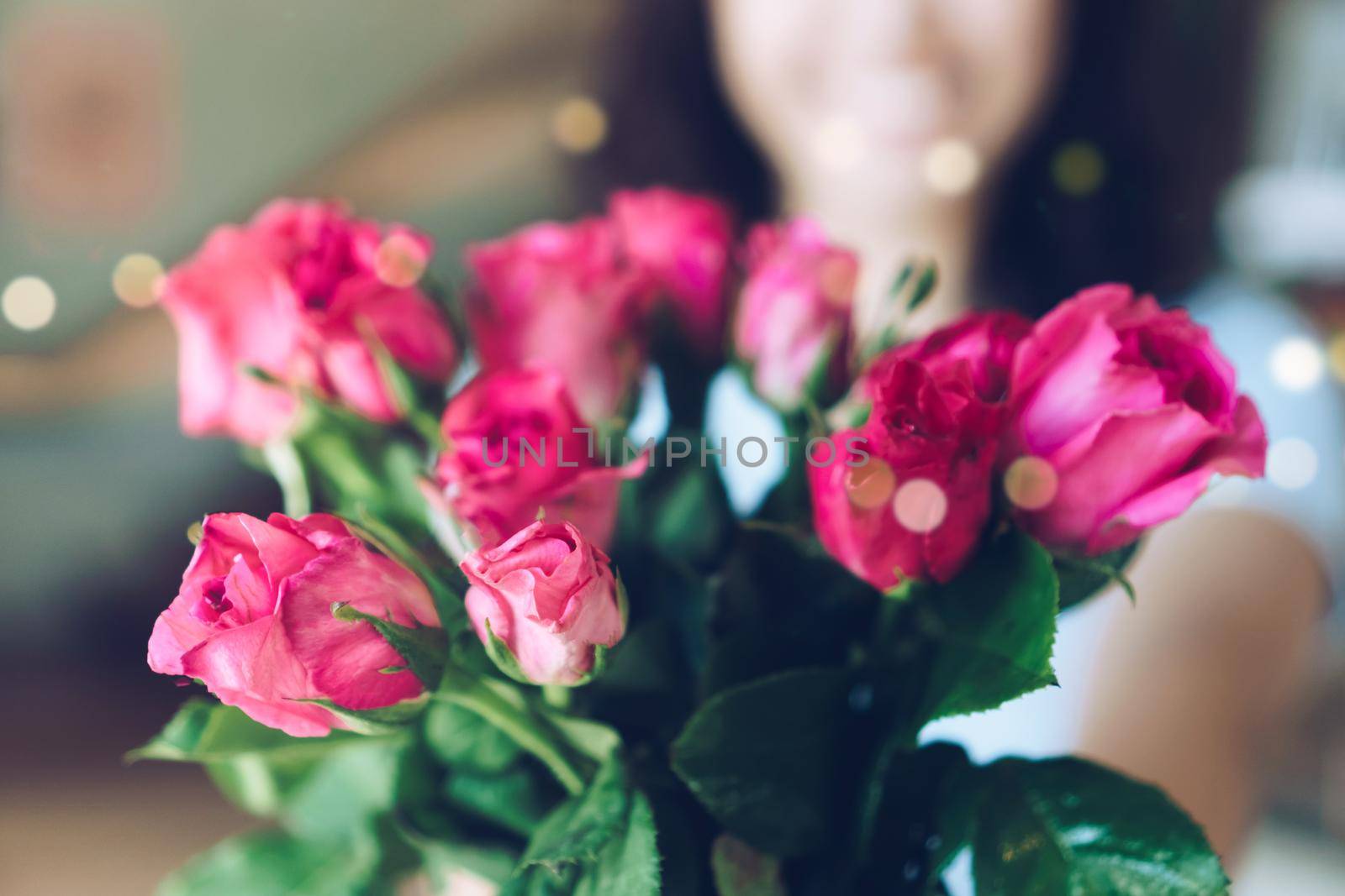 Woman happy hold pink roses recieve from someone in love on Valentine's day.   