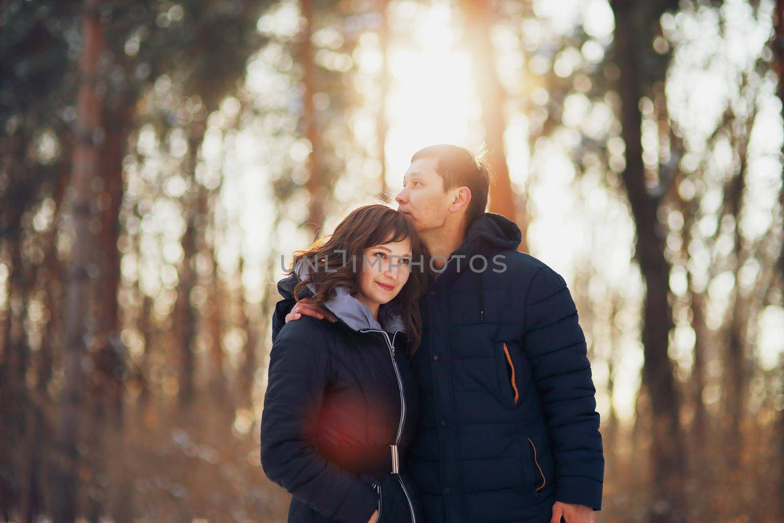 Warm winter portrait of man and woman of asian and caucasian race. 