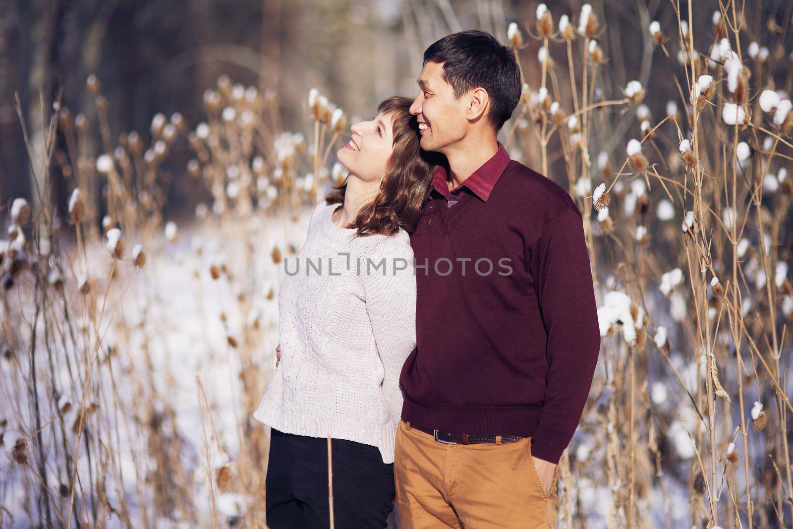 Warm winter portrait of man and woman of asian and caucasian race by selinsmo