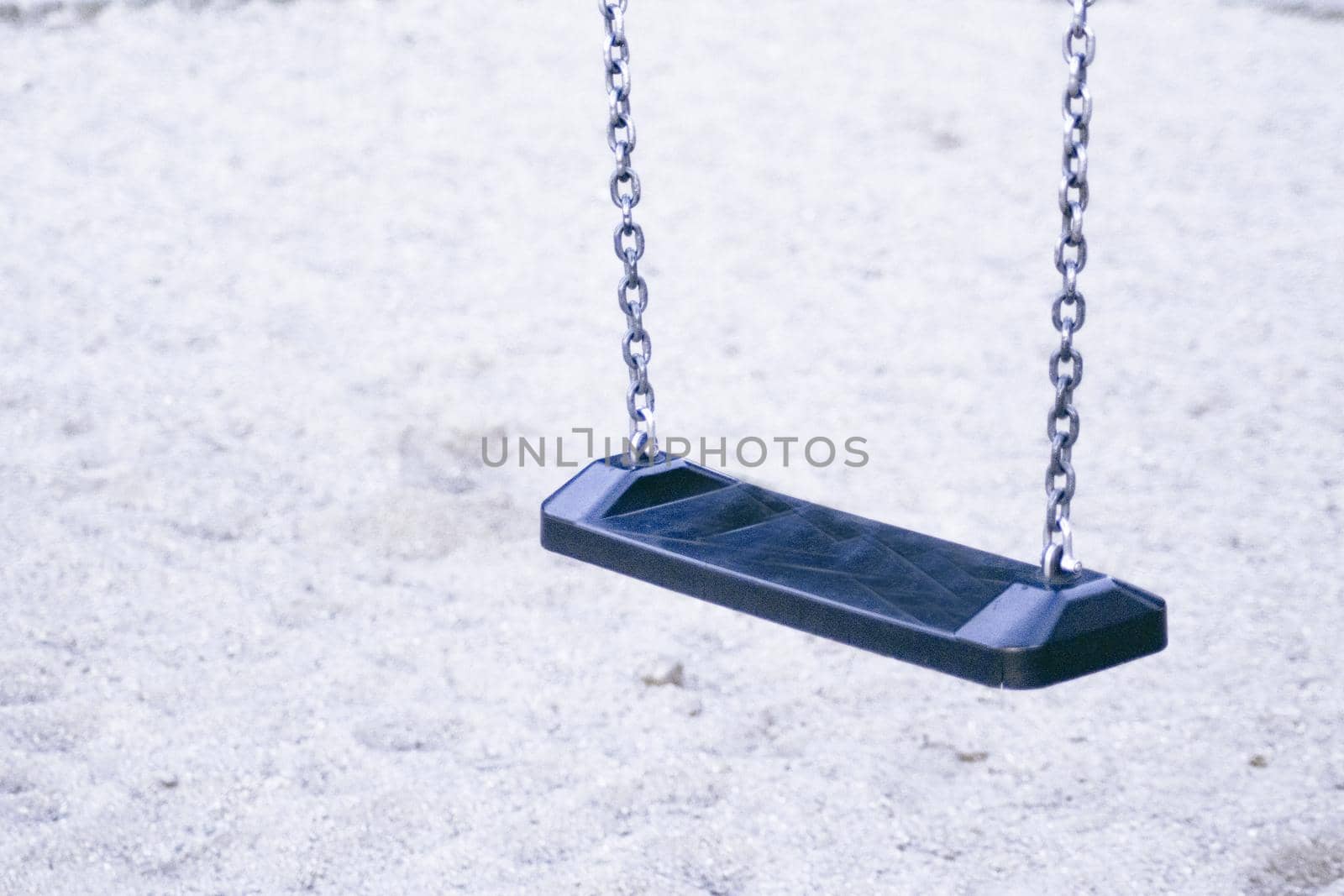 Wooden swing with metal chains for children. No people