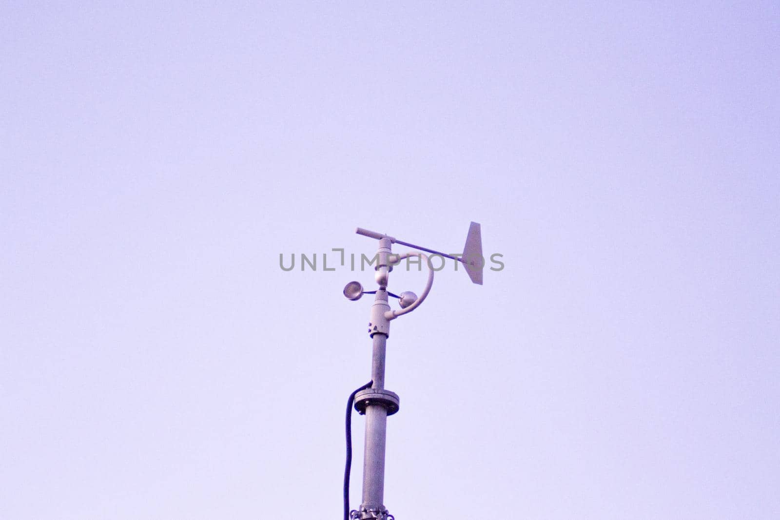 Weather station in silhouette over the sky at sunset. No people