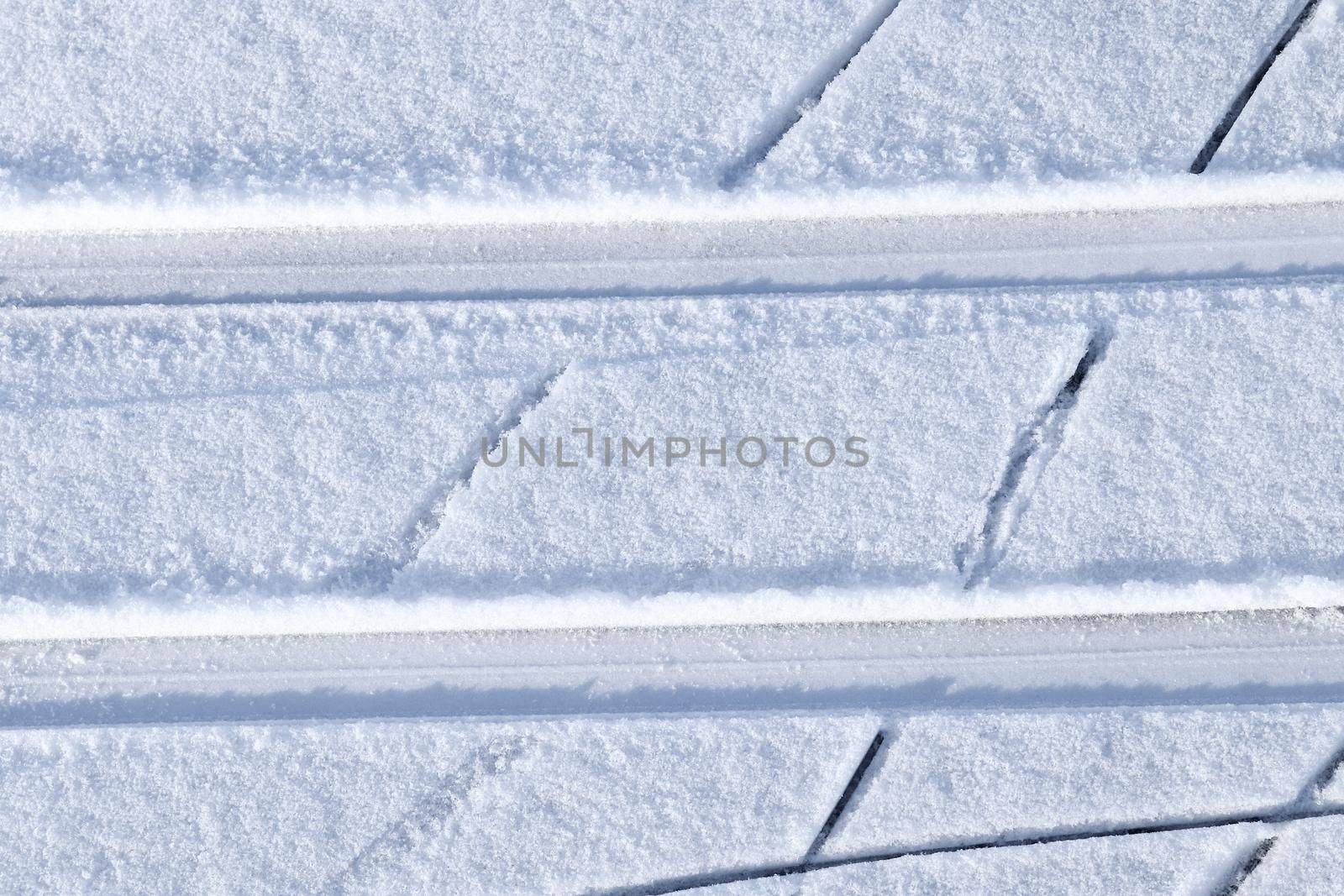 Tire Tracks on snow covered streets in a close up view