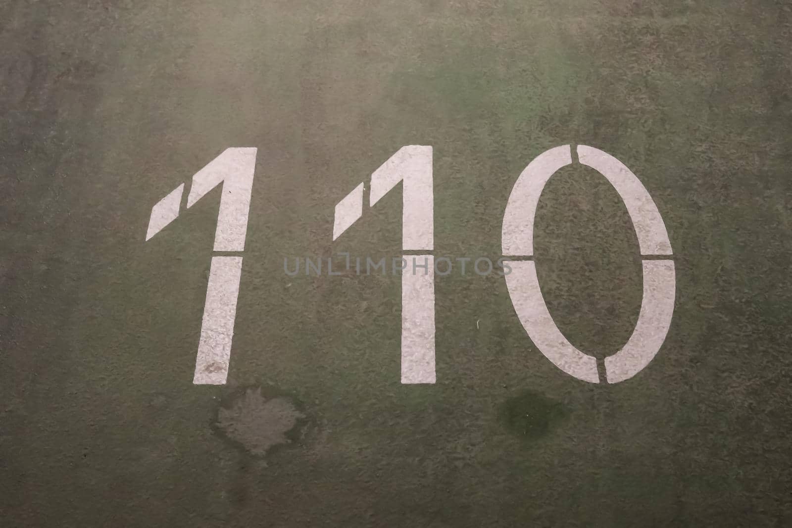 Numbers painted on concrete and asphalt textured surfaces