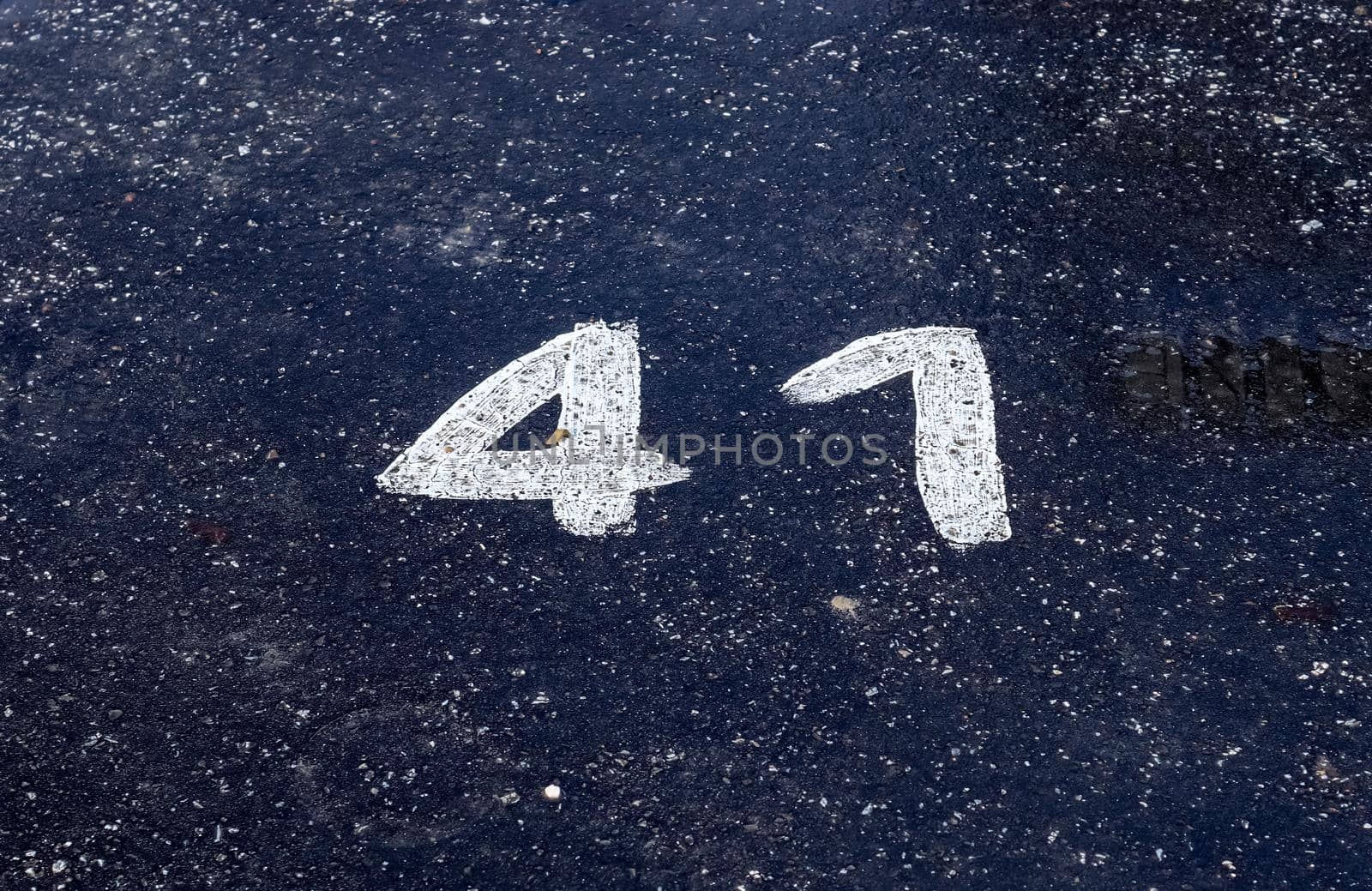 Numbers painted on concrete and asphalt textured surfaces