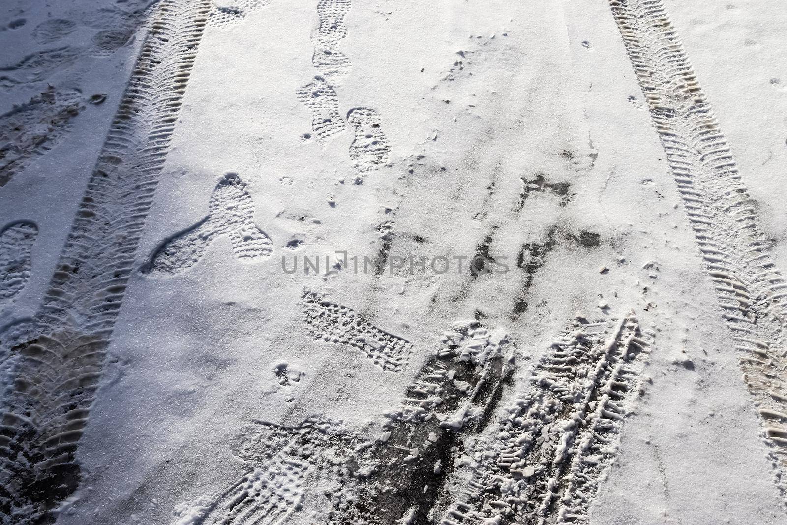 Tire Tracks on snow covered streets in a close up view