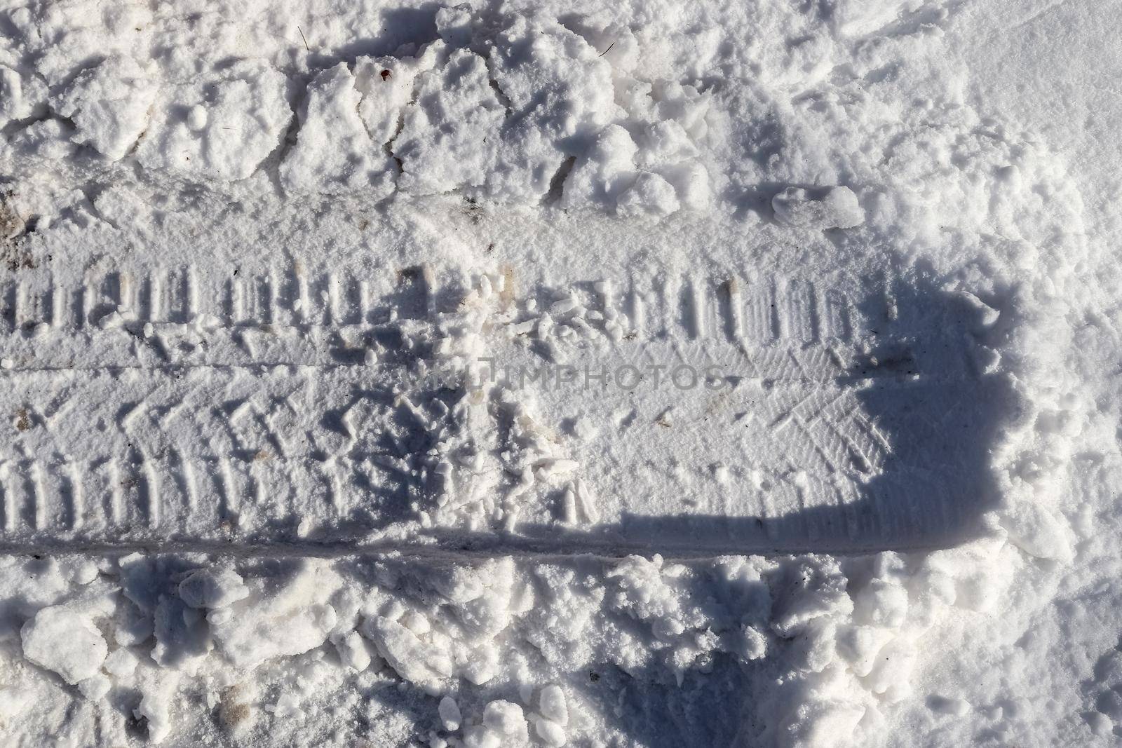 Tire Tracks on snow covered streets in a close up view