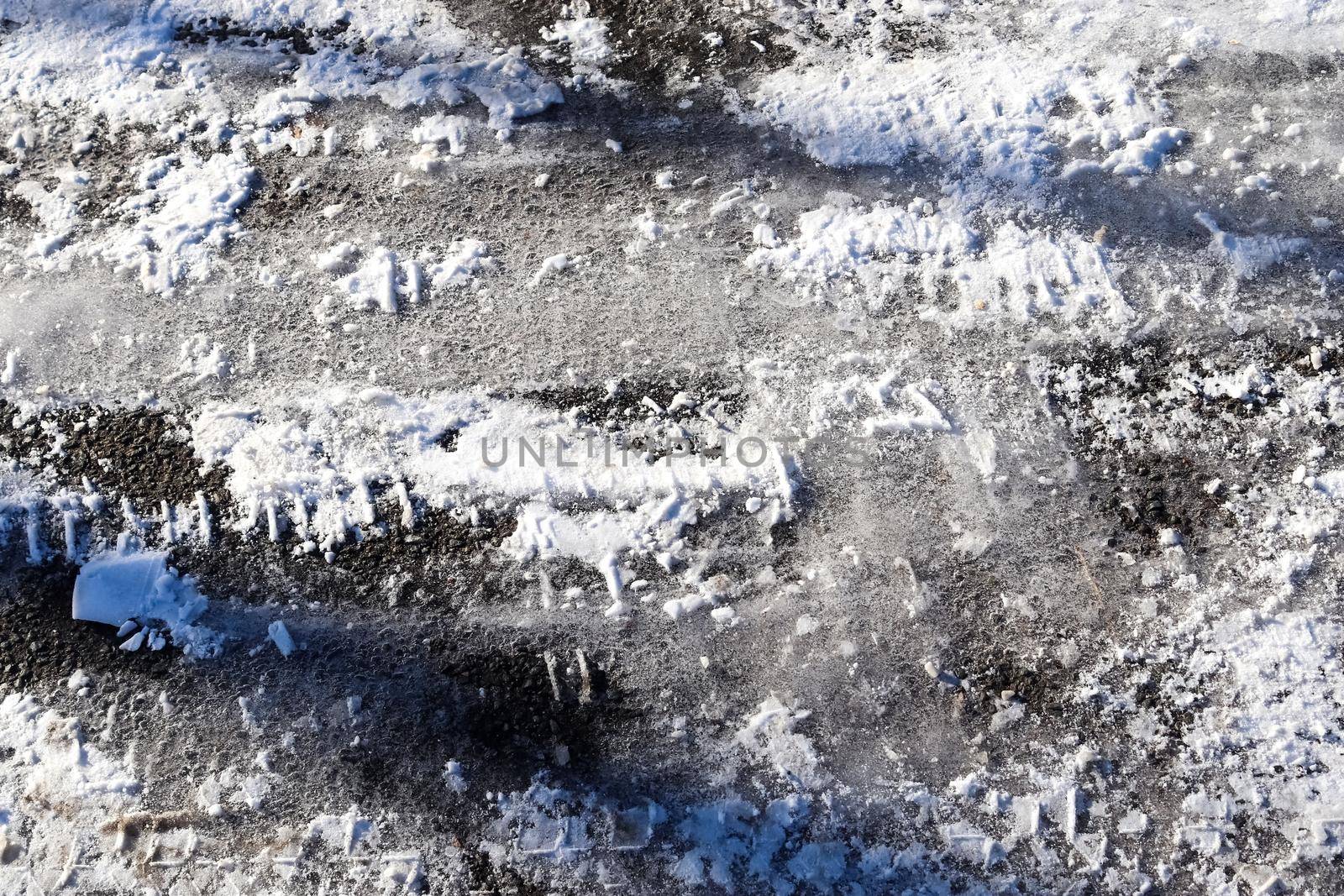 Tire Tracks on snow covered streets in a close up view