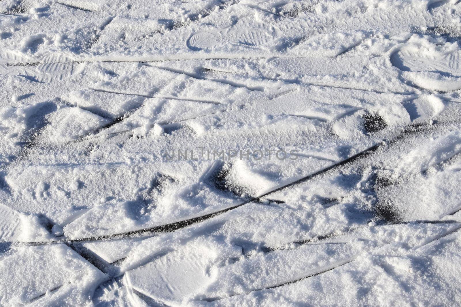 Tire Tracks on snow covered streets in a close up view. by MP_foto71