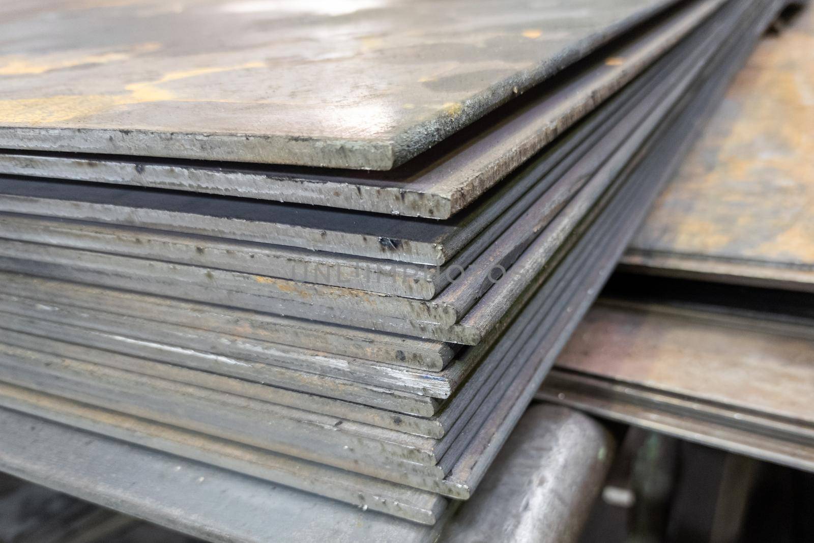 thick hot rolled steel sheets stack corner, close-up.
