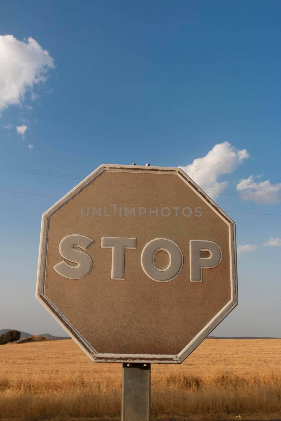 old stop sign on a road by loopneo