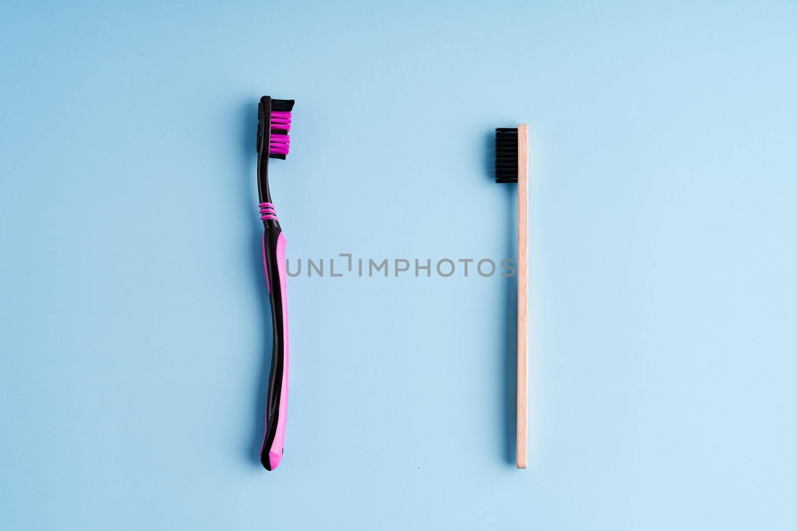 Making choice between plastic toothbrush and eco-friendly bamboo toothbrush. Worldwide Eco trends by Try_my_best