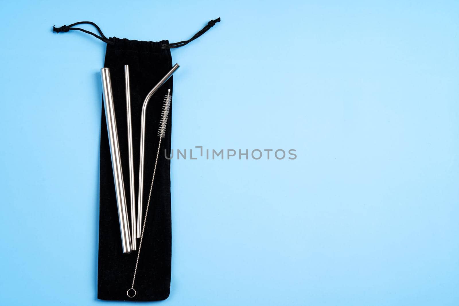 Environmental trend reusable metal beverage straws kit with cleaning tool in transportation bag.