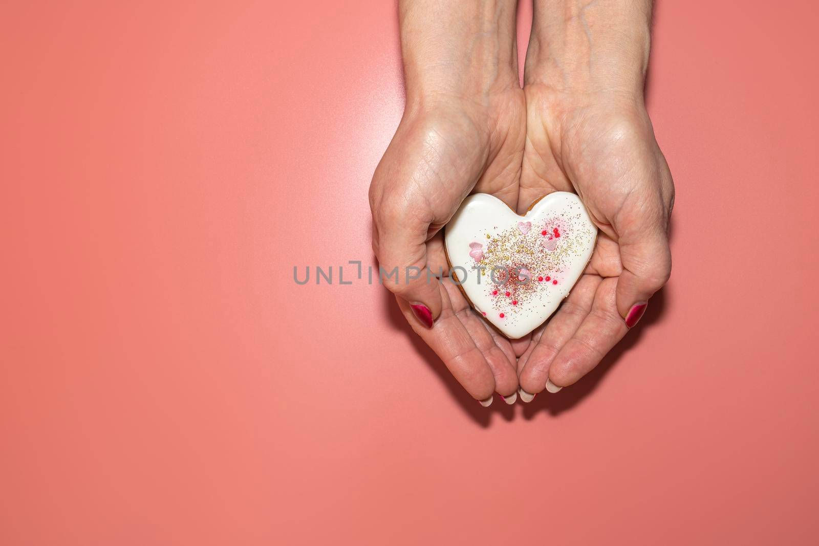 heart in your hands on a pink background. High quality photo