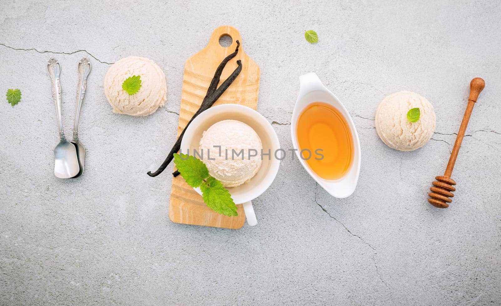 Vanilla ice cream flavor in bowl with vanilla pods setup on concrete background . Summer and Sweet menu concept.