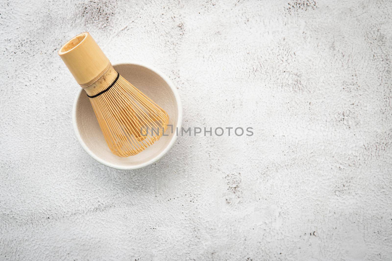 Matcha set bamboo matcha whisk and chashaku tea scoop,matcha ceramic bowl set up on white concrete background.