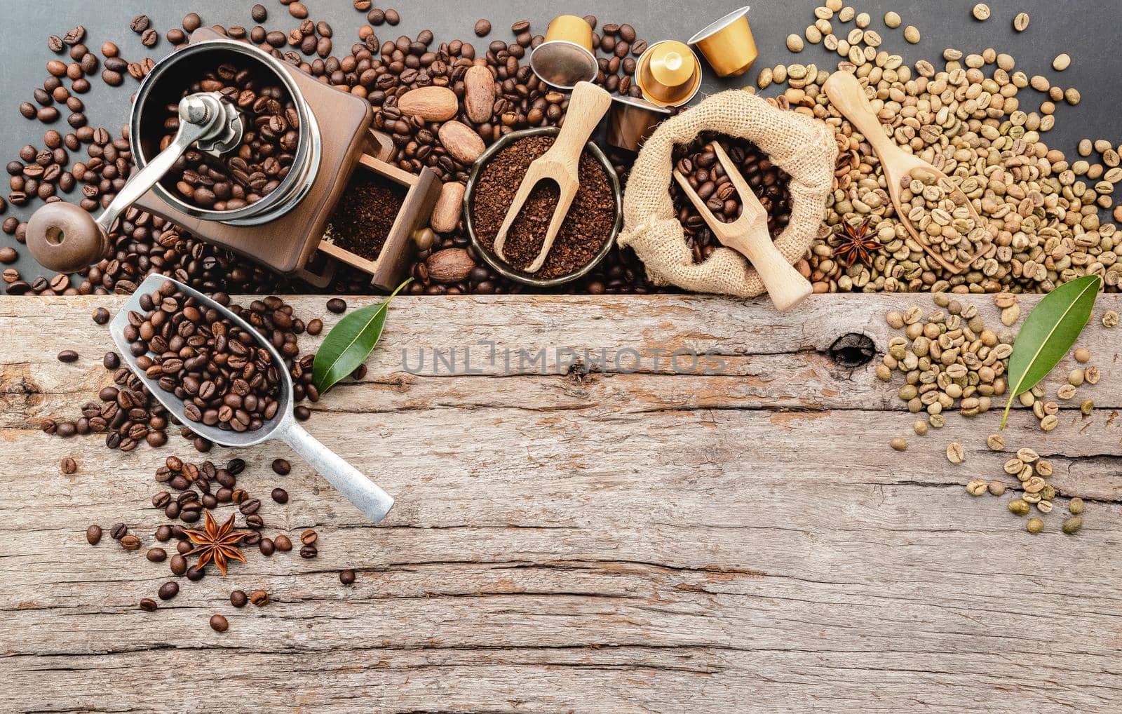 Background of various coffee , dark roasted coffee beans , ground and capsules with scoops setup on wooden background with copy space. by kerdkanno