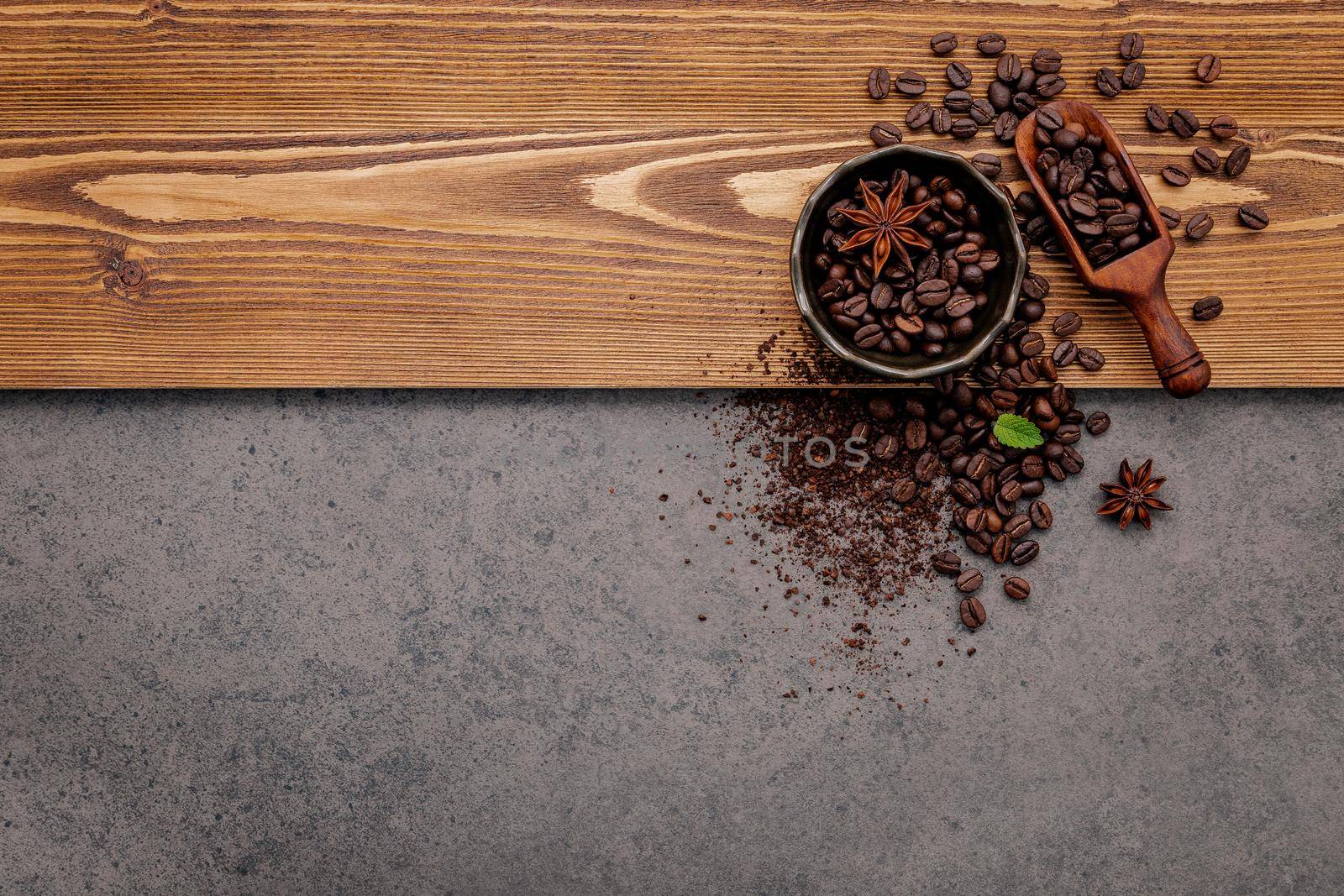  Roasted coffee beans with coffee powder setup on dark stone background. by kerdkanno