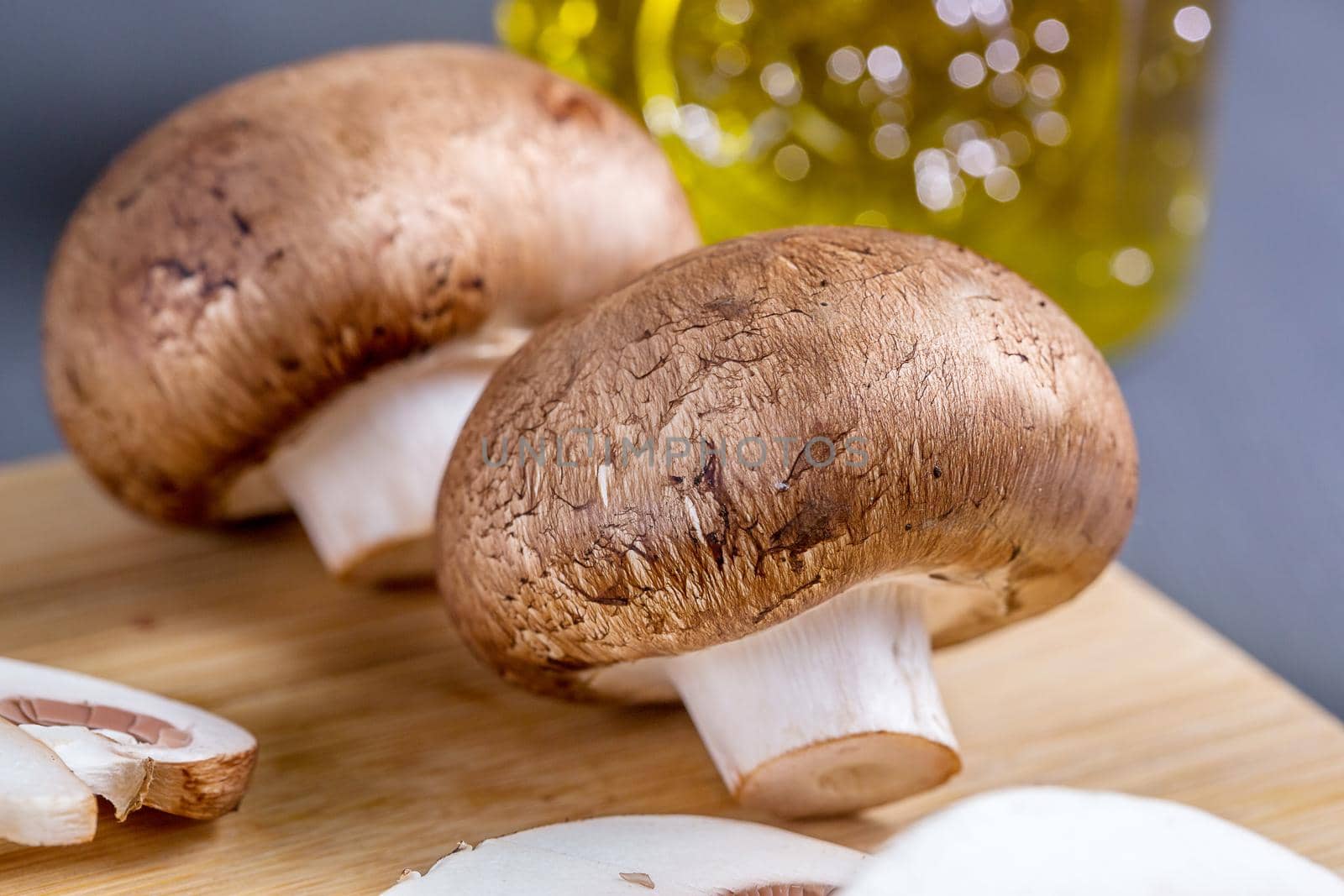 Close-up of edible mushroom Royal champignons, Parisian champignons, on a cutting board. Organic food preparation concept.