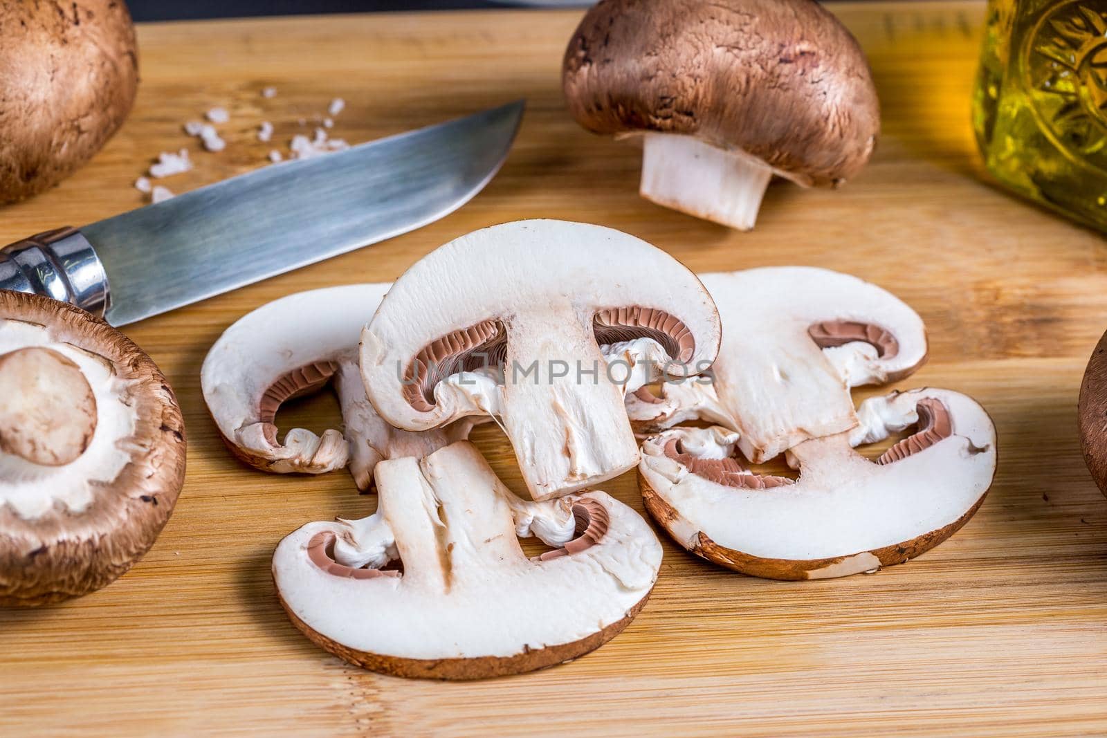 Royal champignons, chopped mushrooms on wooden board by galinasharapova
