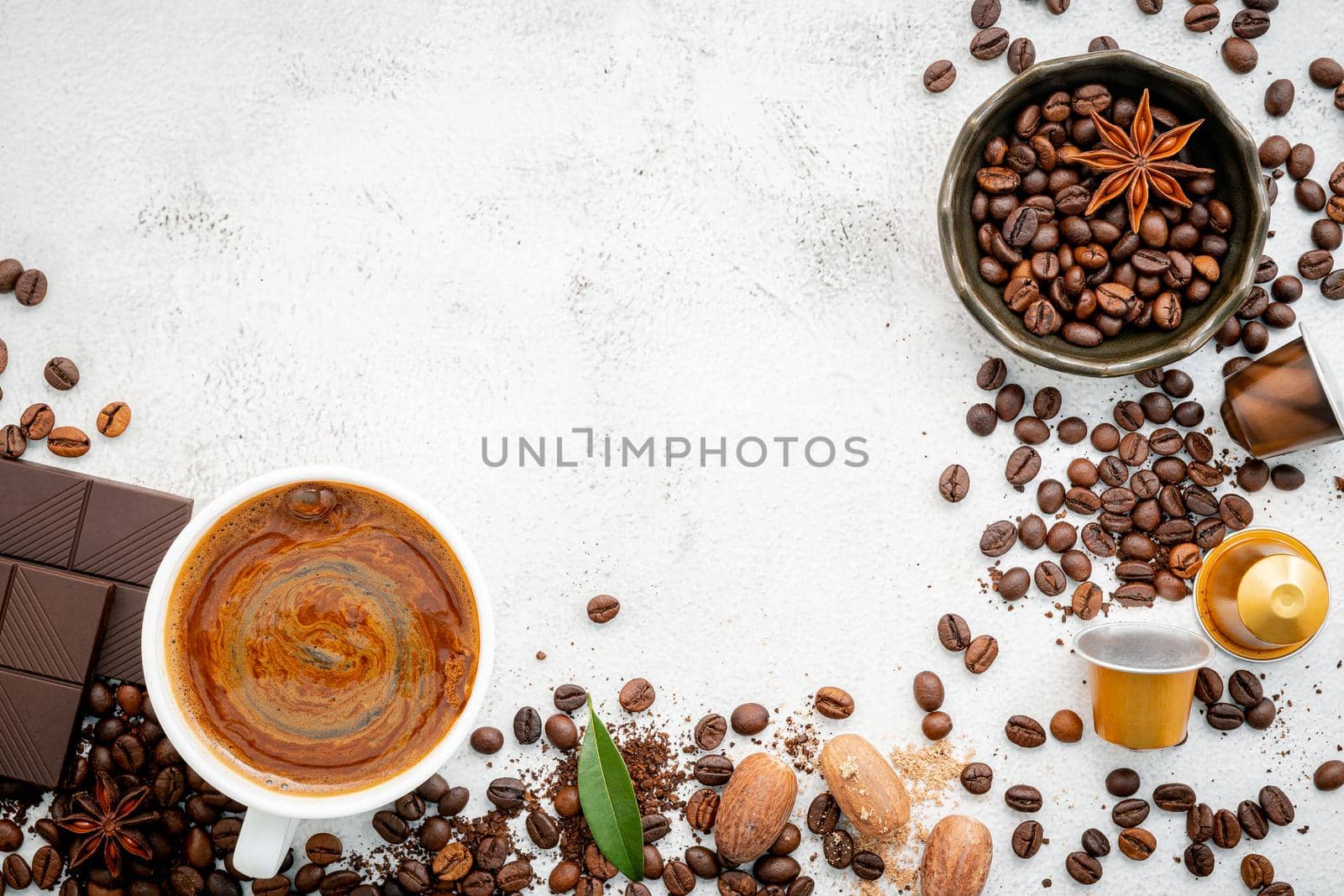 Background of various coffee , dark roasted coffee beans , ground and capsules with scoops setup on white concrete background with copy space.  by kerdkanno