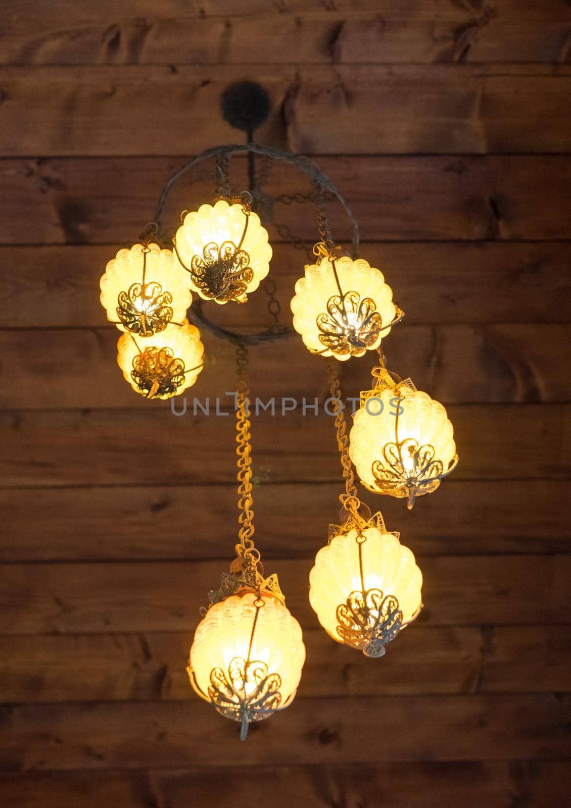 beautiful lamp in vintage style on the background of a wooden ceiling